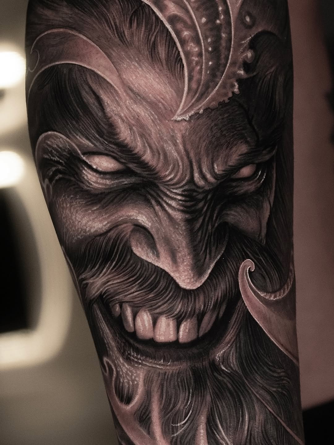 Demonic face realism tattoo on the forearm by @_garart_