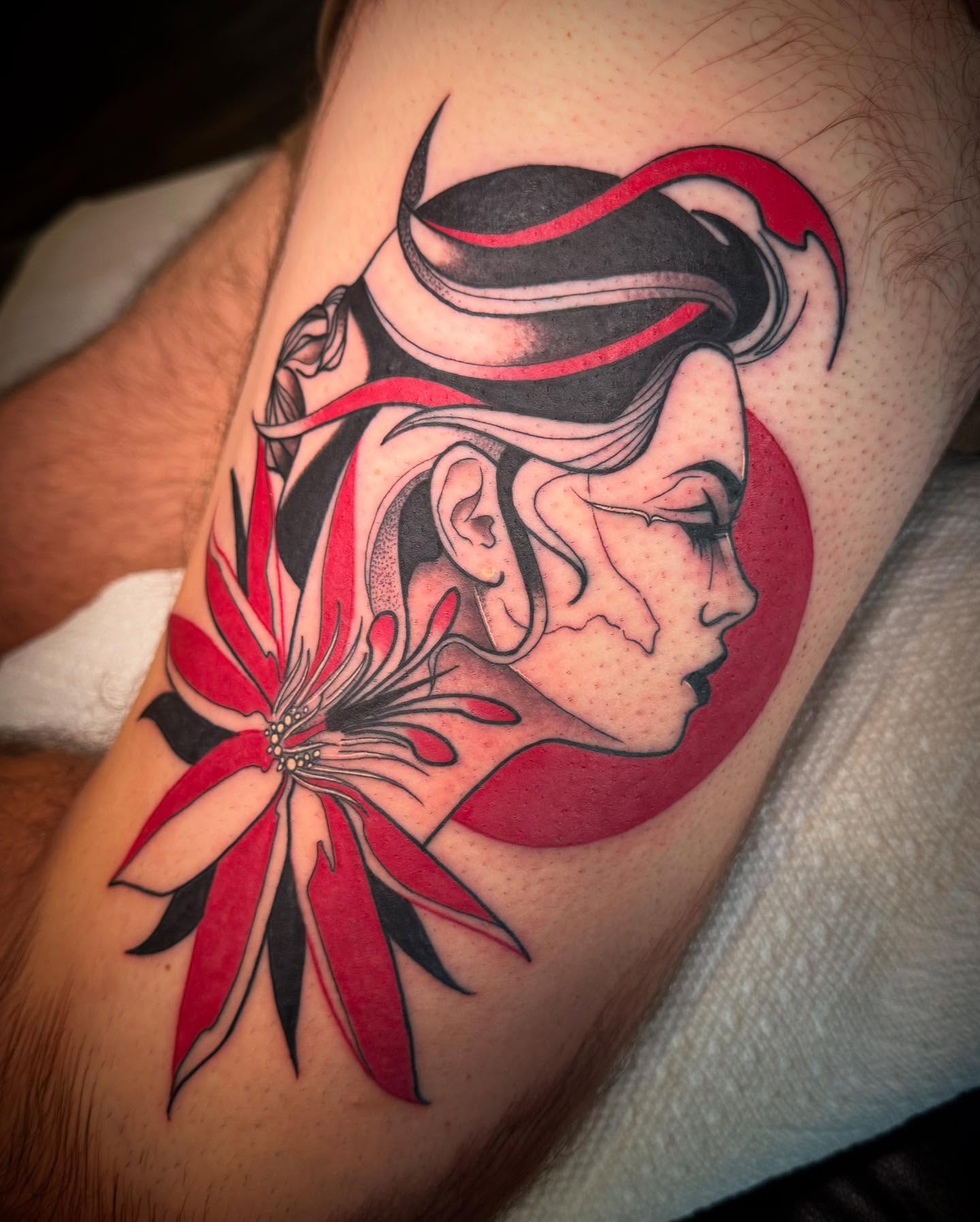 Woman's profile with flower realism tattoo on the forearm by Paul Giovis