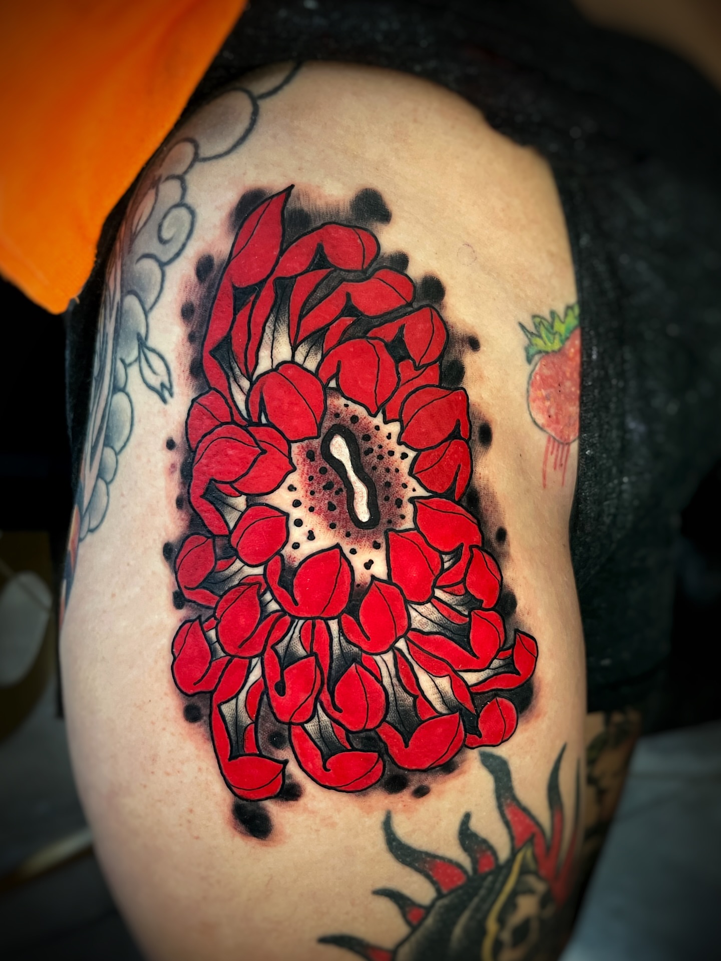 Red petals dotwork tattoo on the shoulder by Gilbert Gonzalez