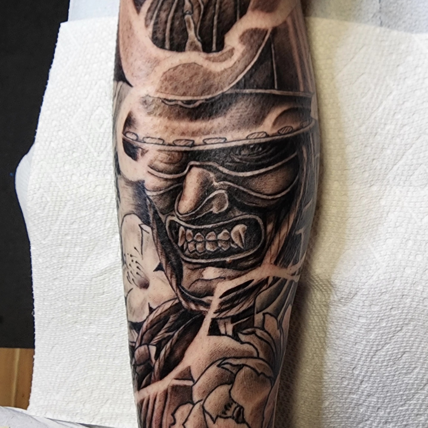 Mask and skull realism tattoo on the forearm by Anthony Moncada