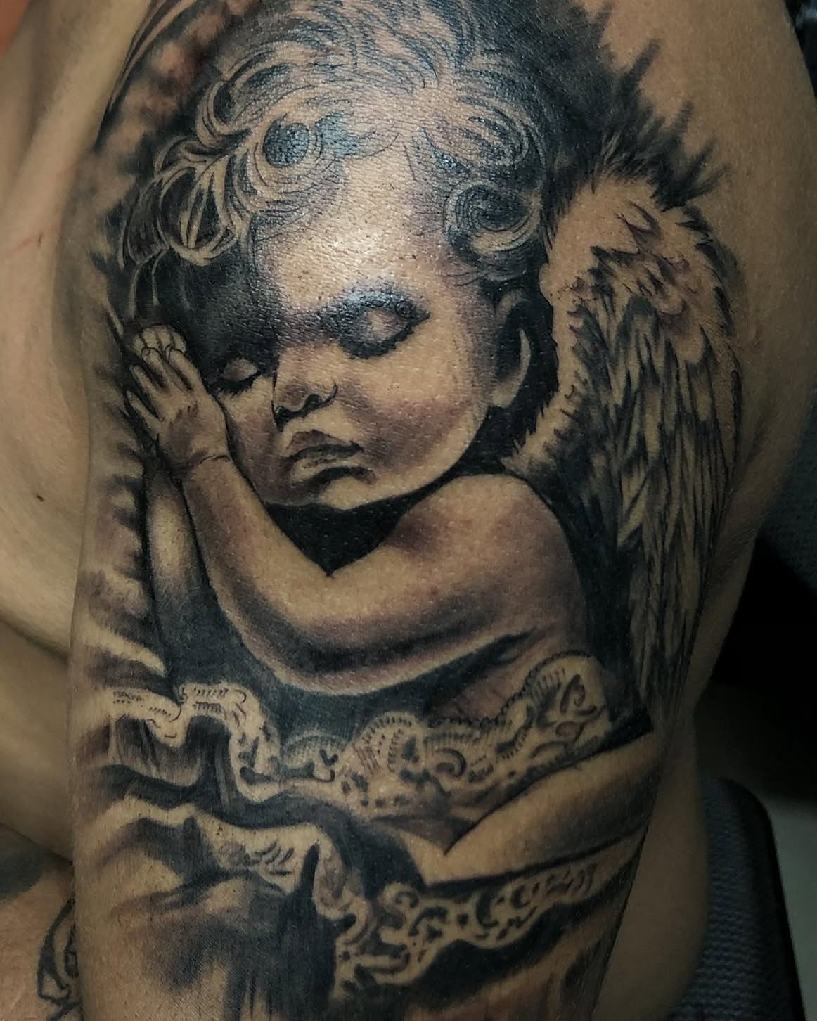 Cherub realism tattoo on the shoulder by Tattooart-gotha, Juchitan, Oaxaca, Mexico