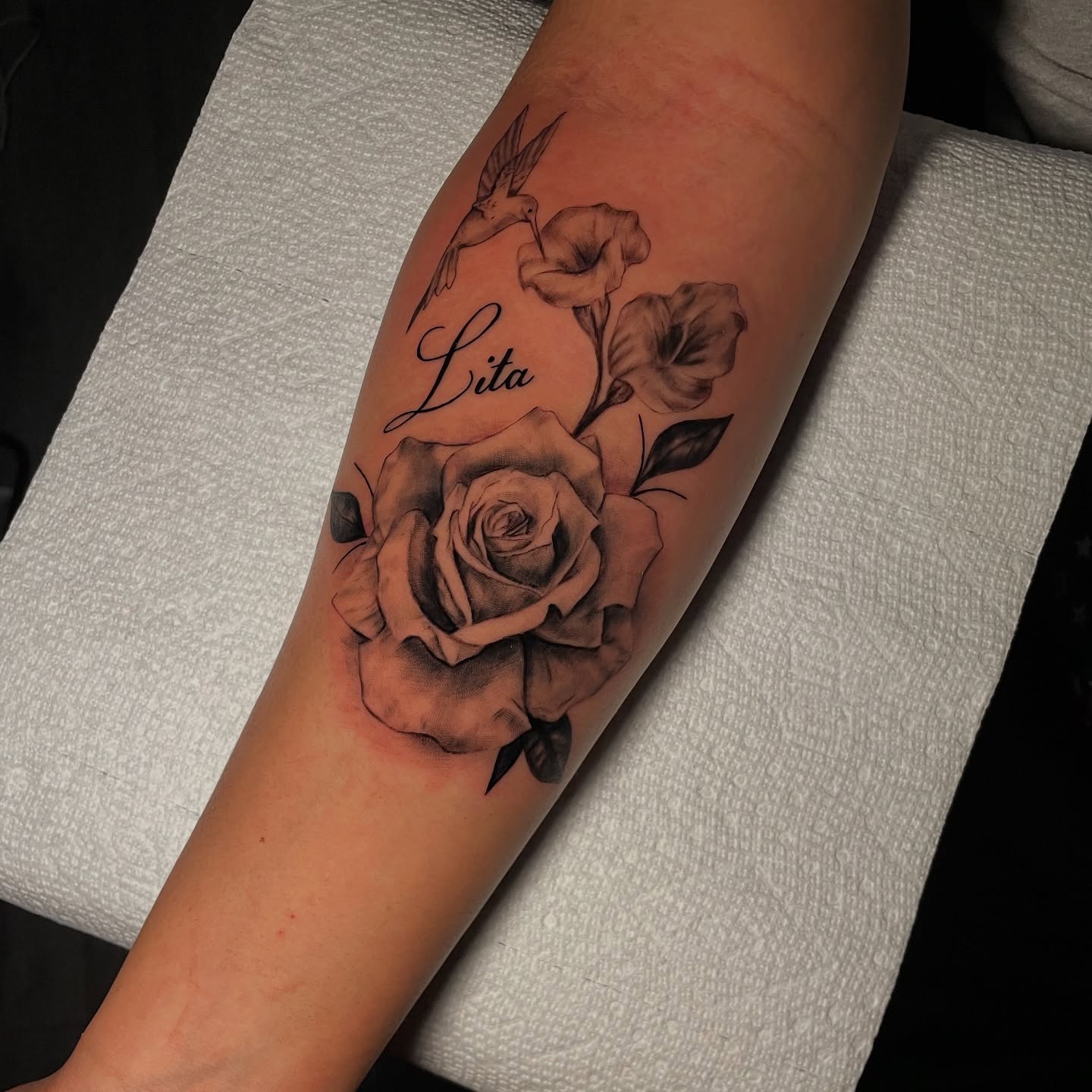 Rose and hummingbird realism tattoo on the forearm by Tattoo Artist