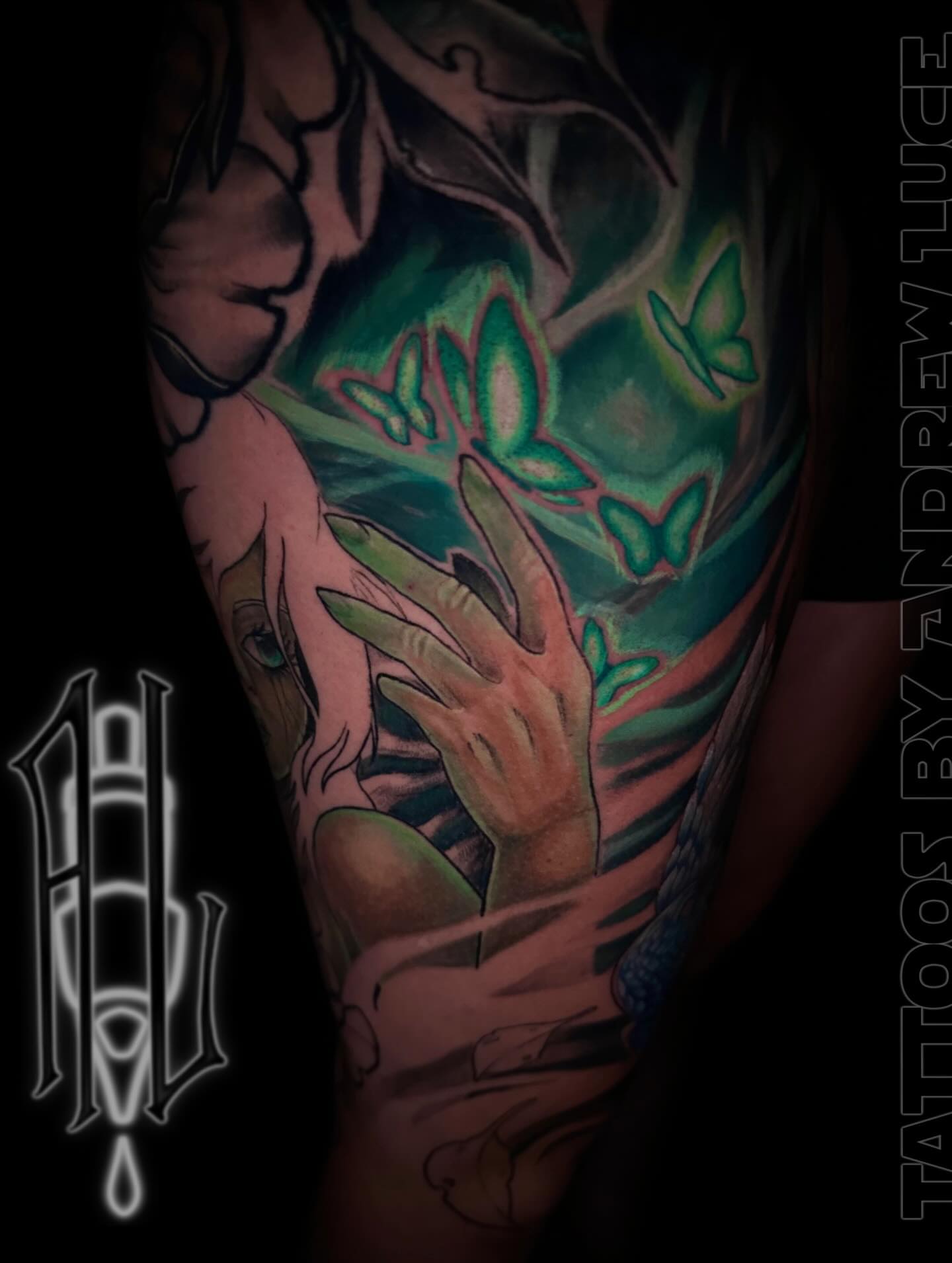 Hands and butterflies realism tattoo on the upper arm by Andrew Luce