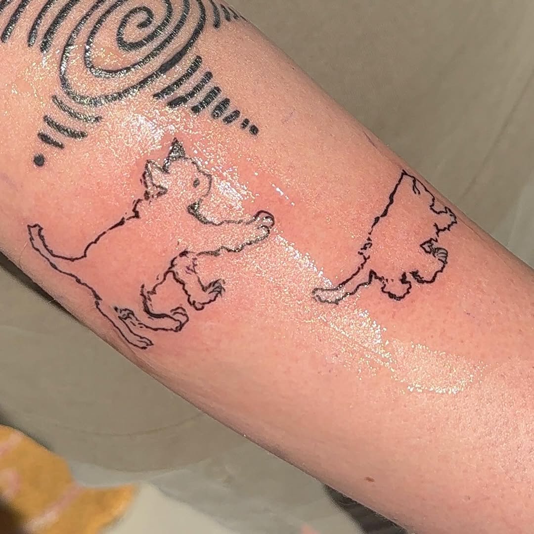 Two cats playing minimalist tattoo on the forearm by Boise Tattoo Artist