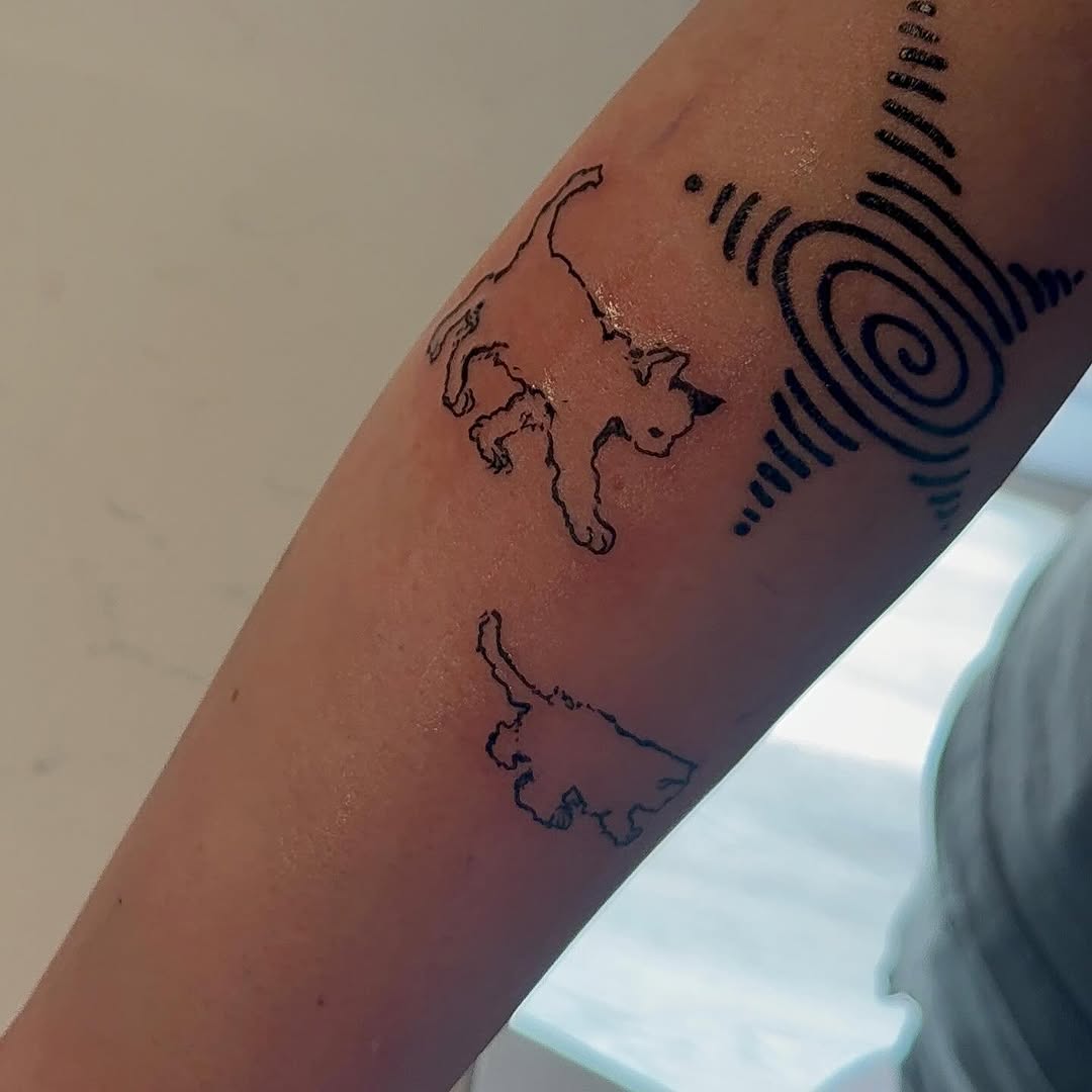 Two cats and a spiral design minimalist tattoo on the forearm by Boise Tattoo Artist