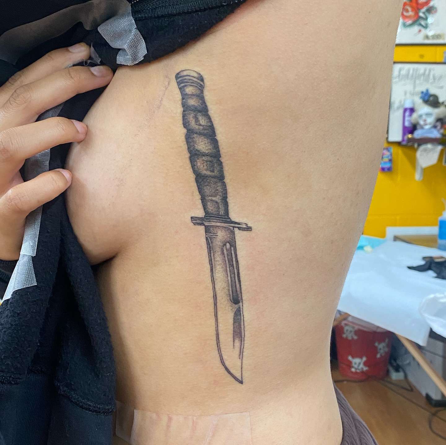Knife black and grey tattoo on the ribs by Joey Delarosa, San Francisco, California