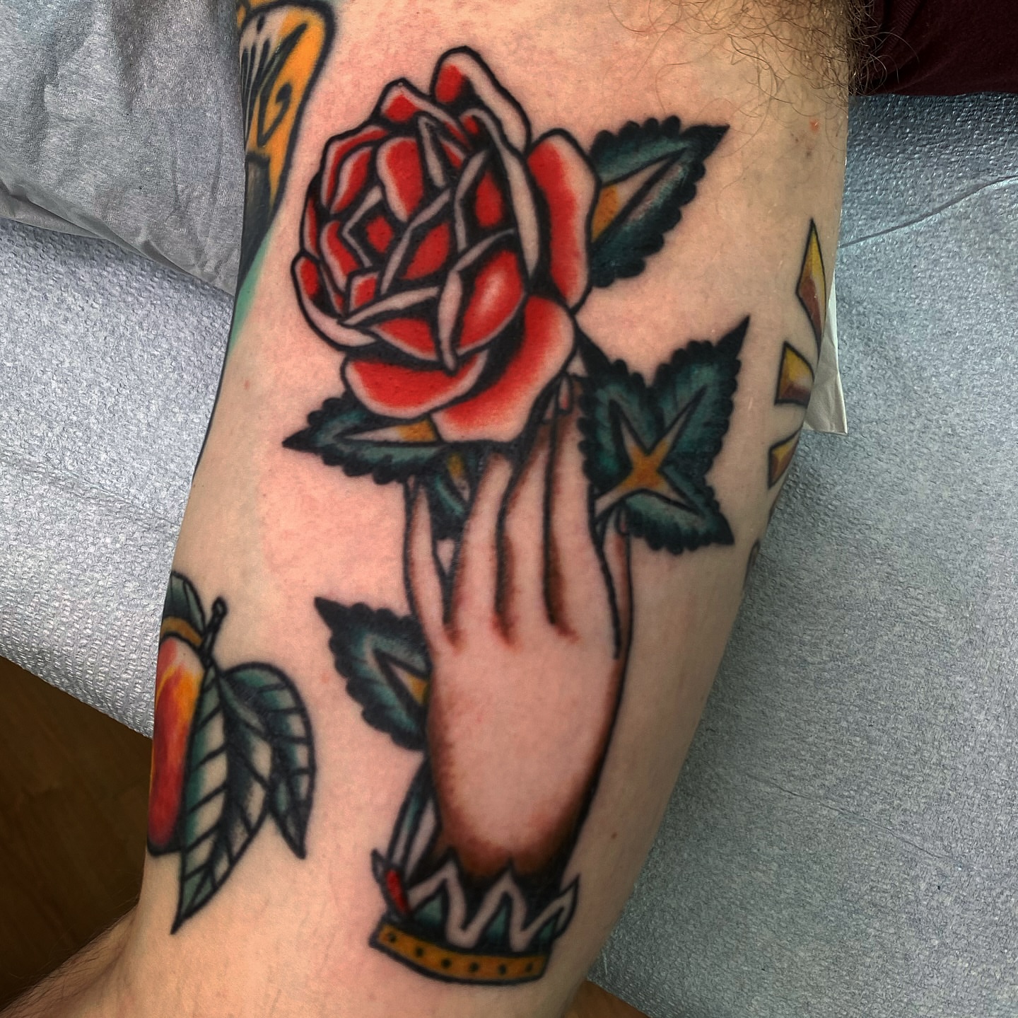 Rose and hand American traditional tattoo on the forearm by Joey Delarosa, San Francisco, California