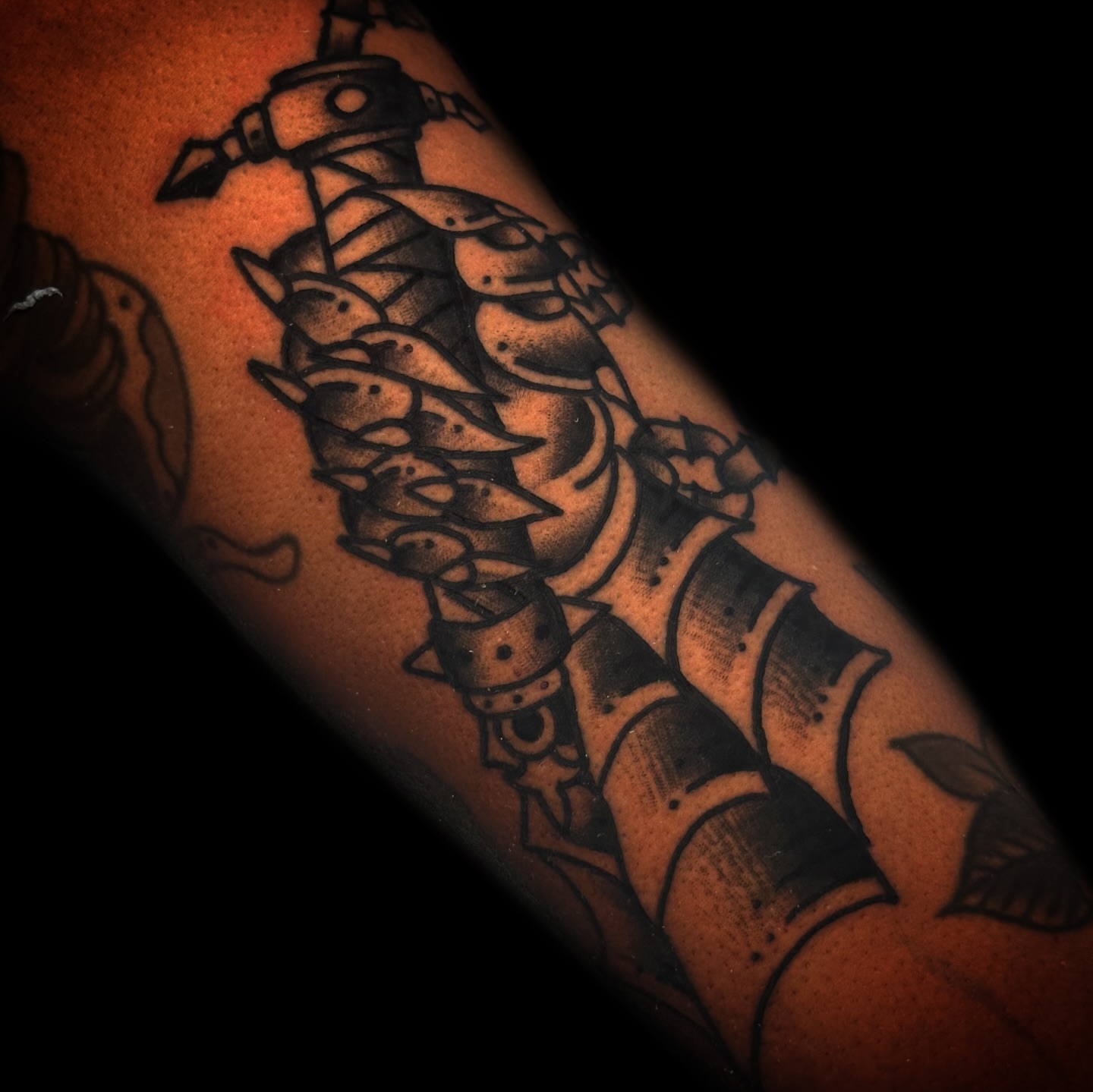 Ship and dolphins black and grey tattoo on the forearm by Danny Reis