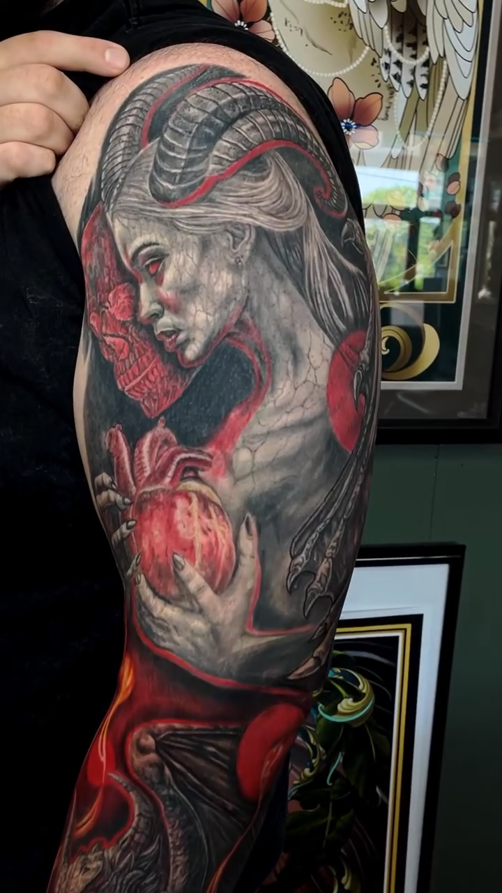 Demonic woman with heart realism tattoo by Rick Elliott