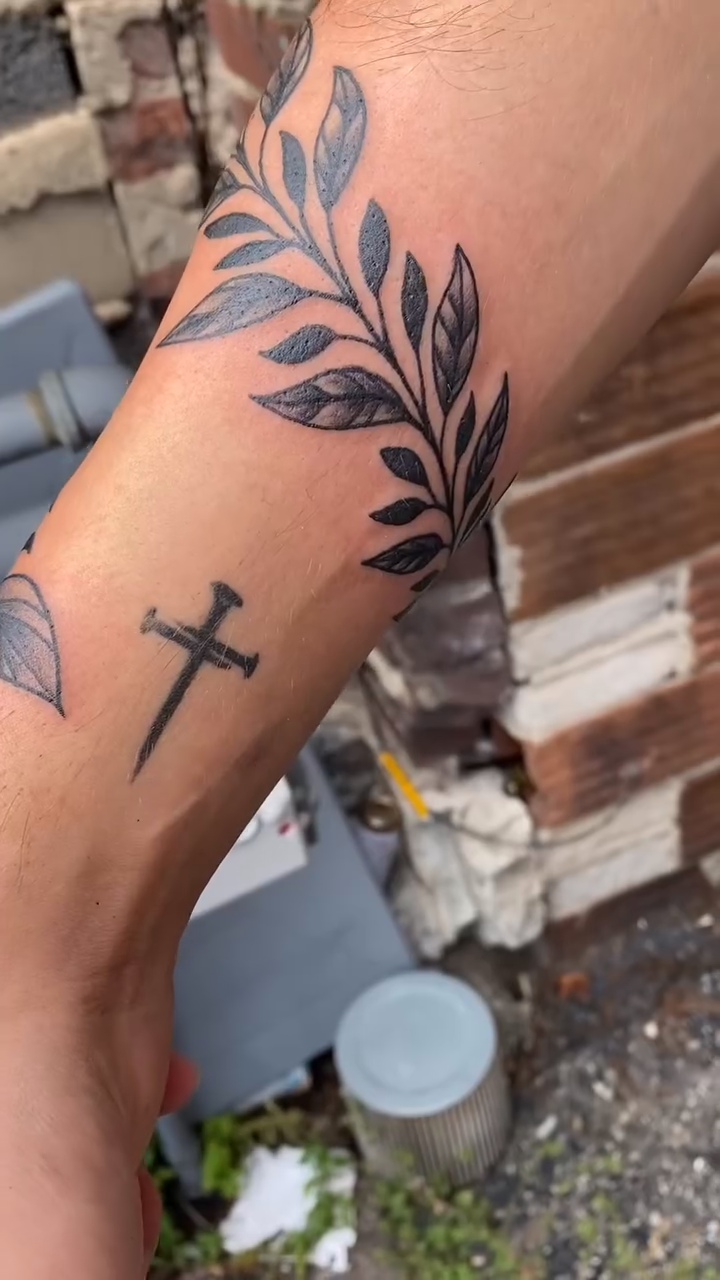 Laurel branches and a cross dotwork tattoo on the forearm by jim collins, Dayton, Ohio