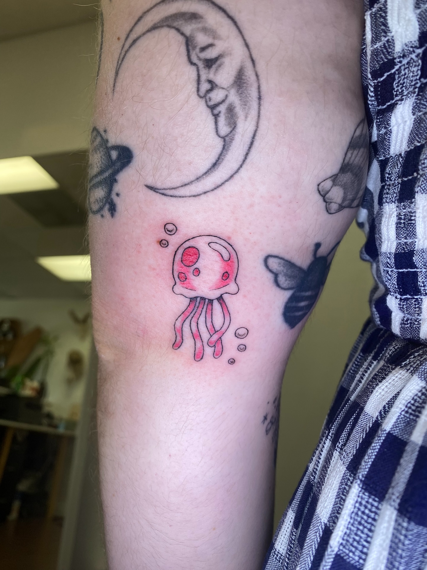 Jellyfish watercolor tattoo on the forearm by Melissa Contreras