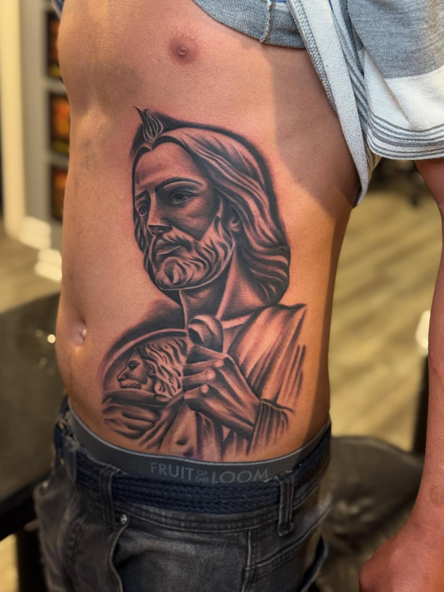 Religious figure black and grey tattoo on the ribs by Stephanie Cruz, Kansas City, Missouri