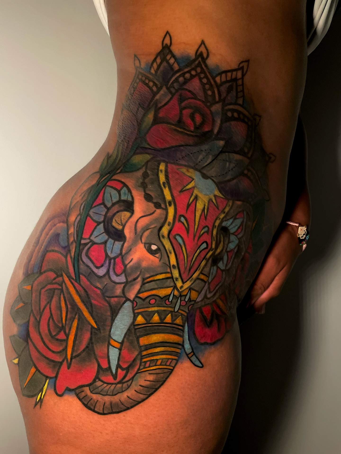 Elephant and roses American traditional tattoo on the thigh by Tattoo Artist
