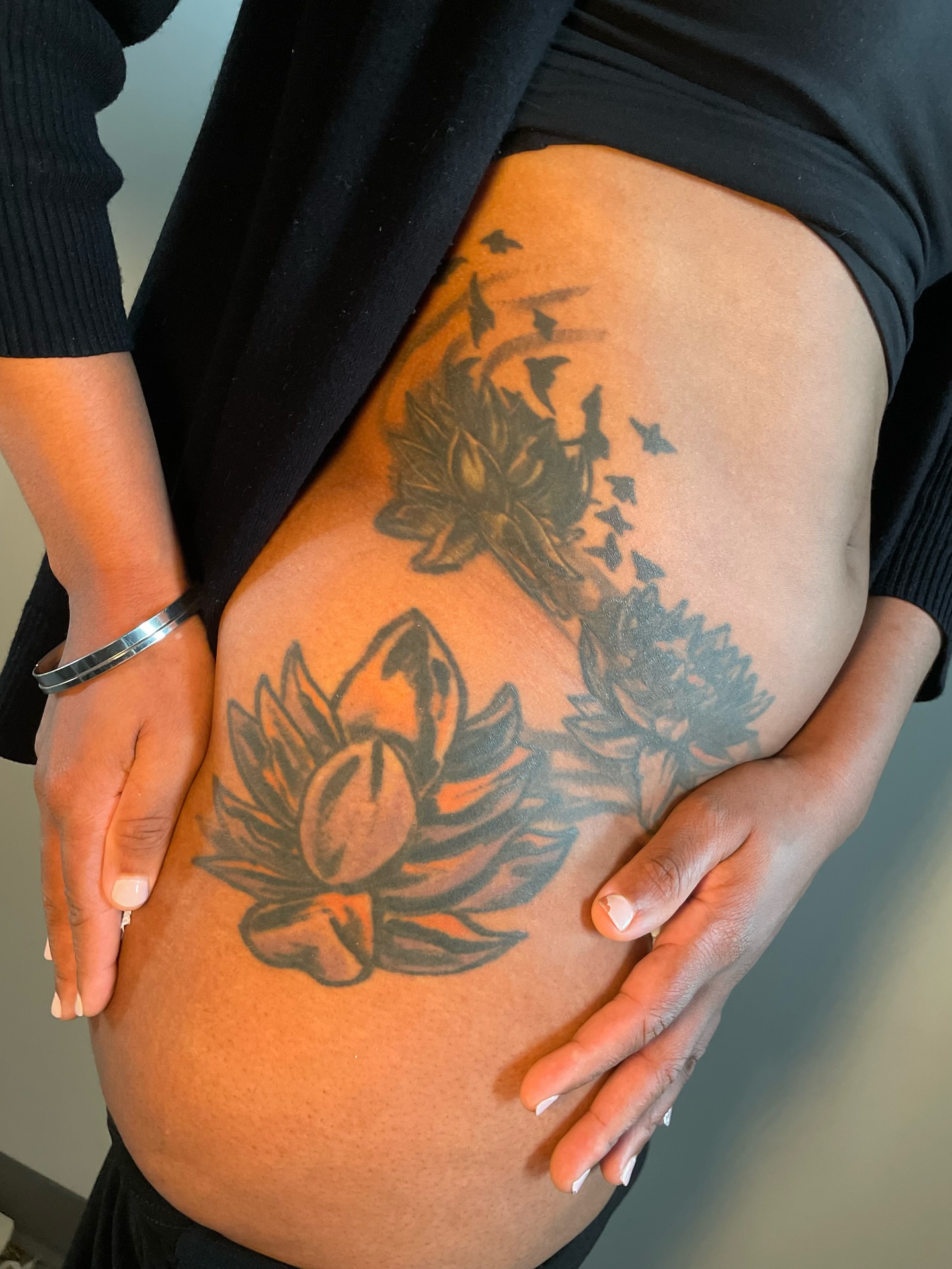 Lotus flower black and grey tattoo on the thigh by Tattoo Artist
