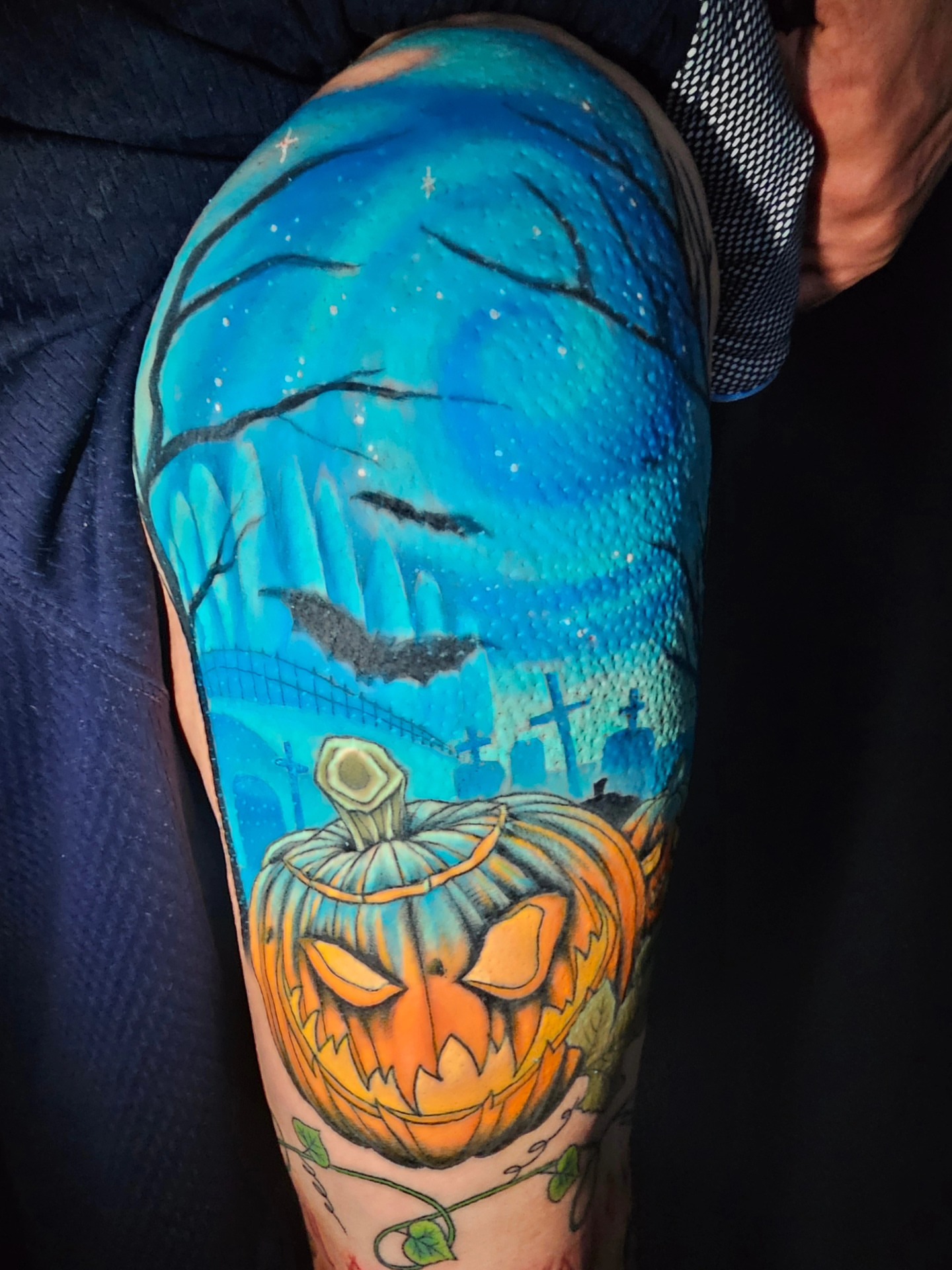 Pumpkin jack-o'-lantern dark realism tattoo on the upper arm by Ashwee Hart