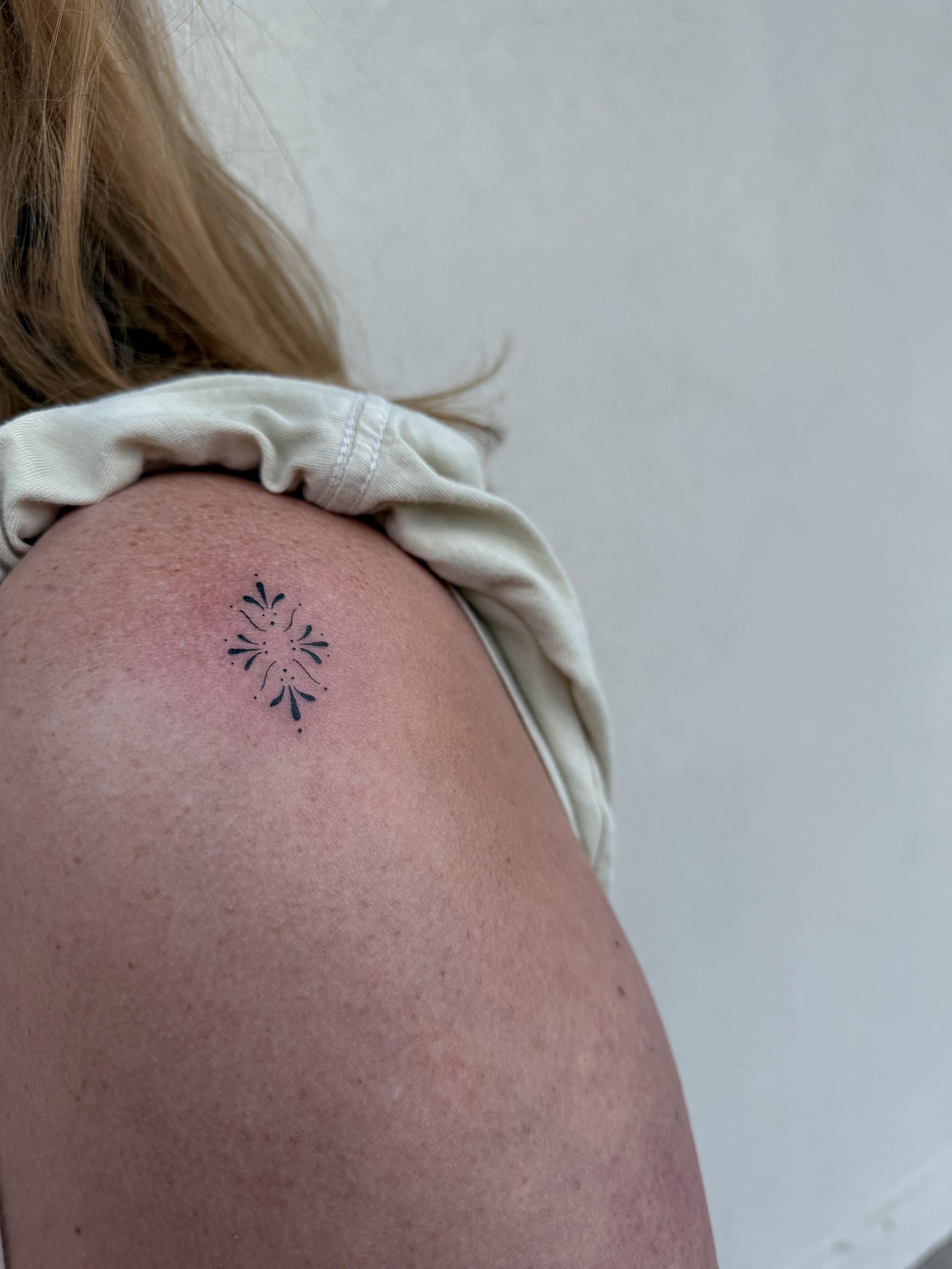 Snowflake geometric tattoo on the shoulder by Abby Robinson