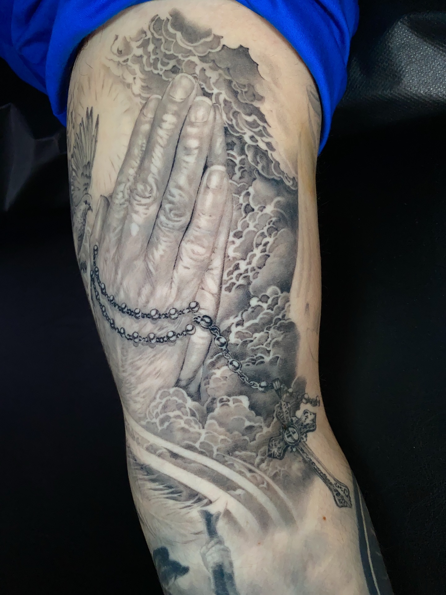 Praying hands realism tattoo on the forearm by Gerardo Brawder