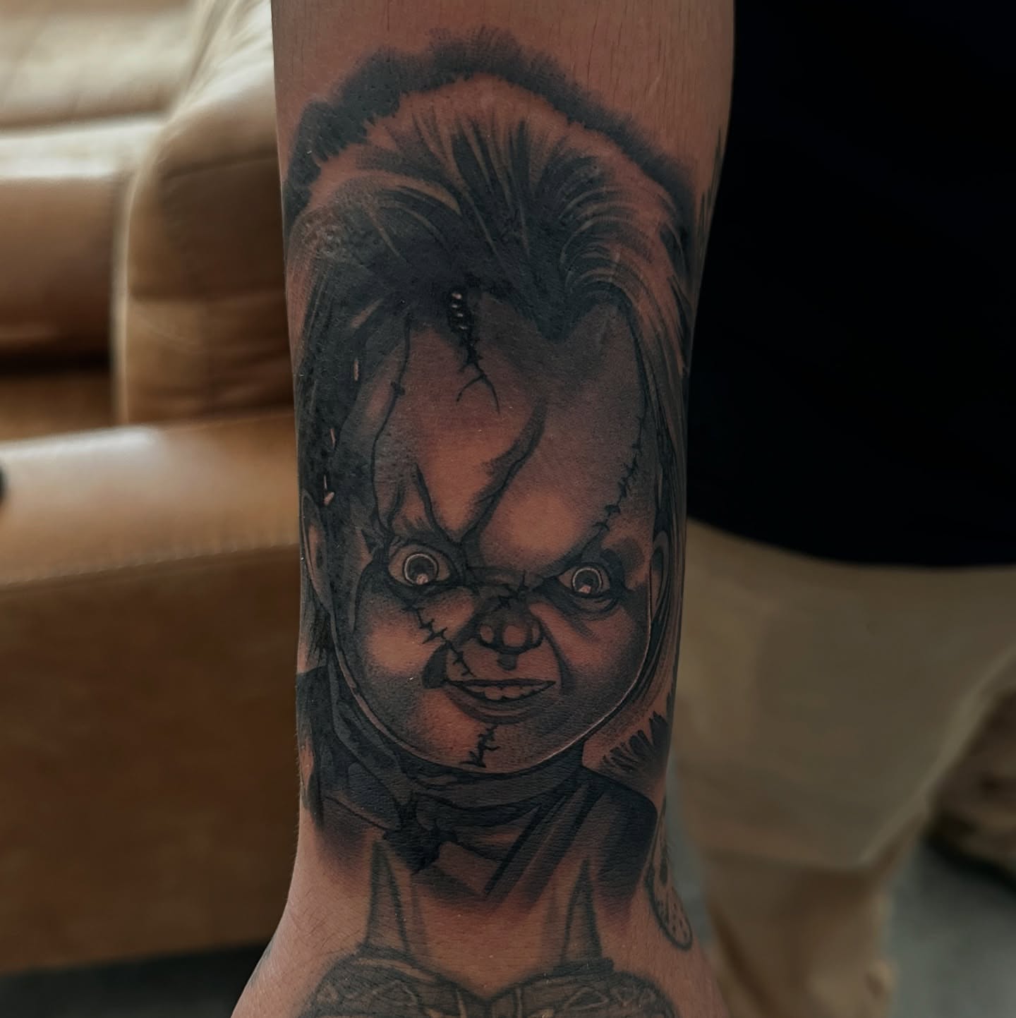 Chucky doll black and grey tattoo on the forearm by Bigtoons21