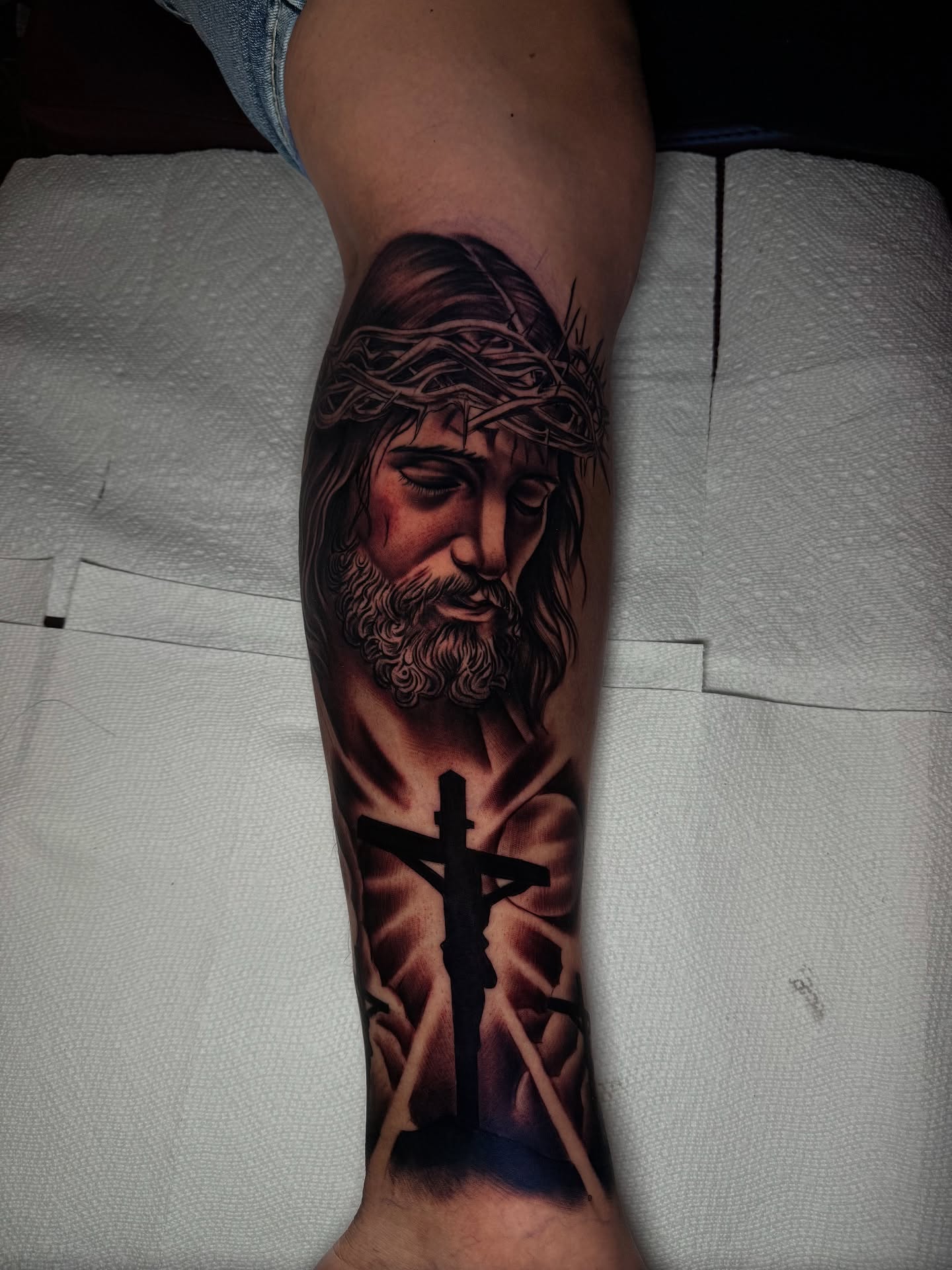 Jesus Christ realism tattoo on the forearm by Aaron Saenz jr