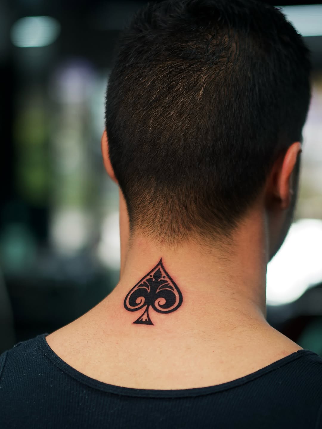 Ace of spades tribal tattoo on the neck by @blackastaratattoo
