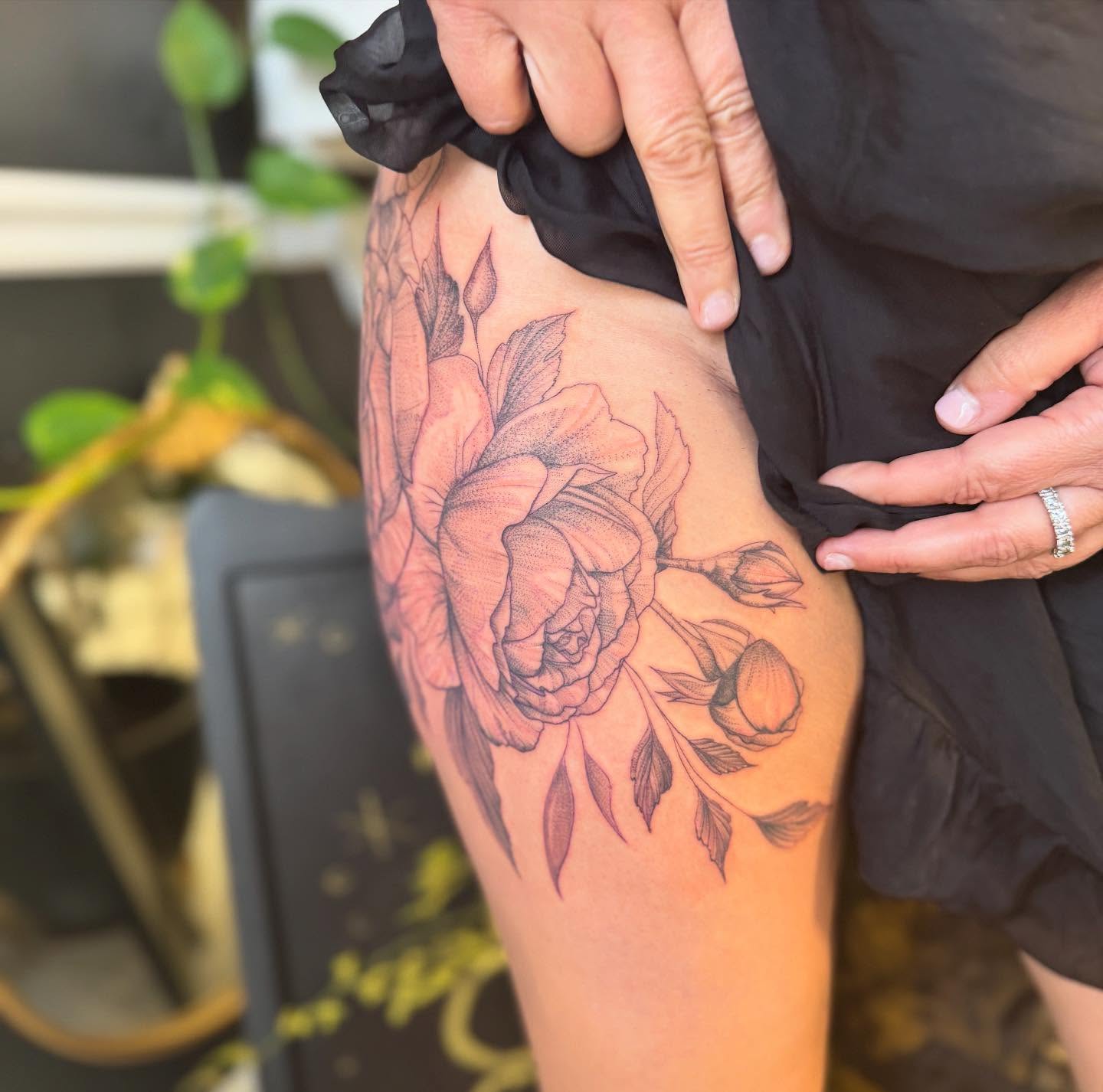 Floral bouquet black and grey tattoo on the thigh by Aura Noire
