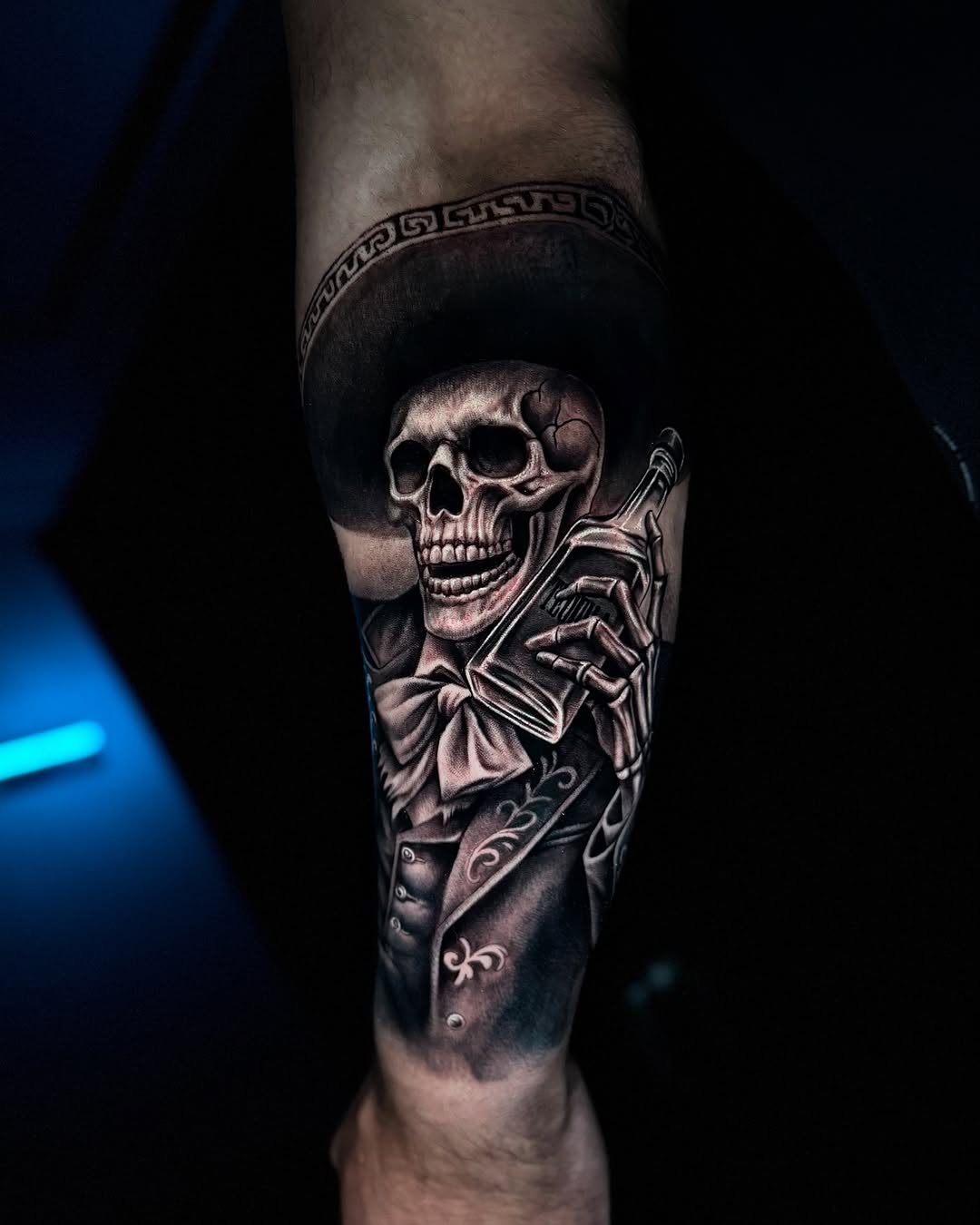 Skeleton in sombrero holding bottle realism tattoo on the forearm by Tommy Nguyen, Eastpointe, Michigan