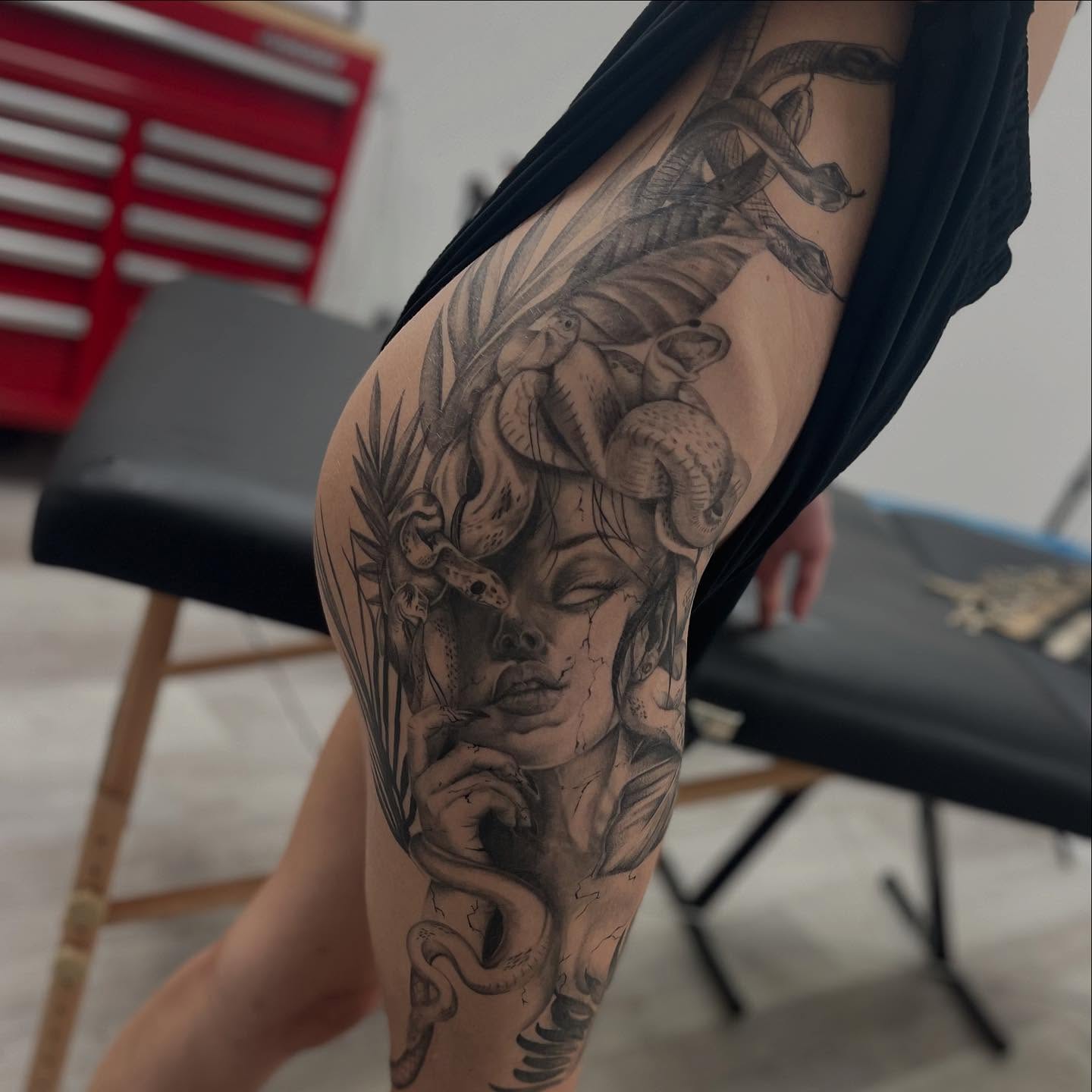 Woman with snakes realism tattoo on the thigh by Antonio