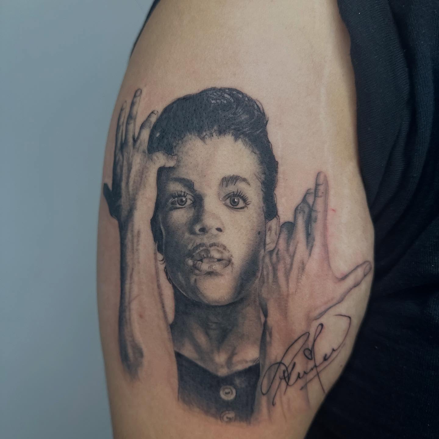 Portrait realism tattoo on the upper arm by Antonio