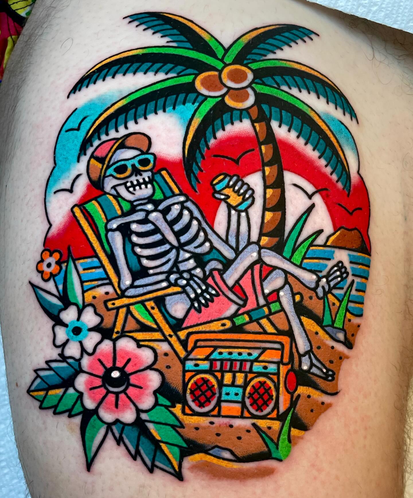 Skeleton relaxing American traditional tattoo on the thigh by Ryan McDonald
