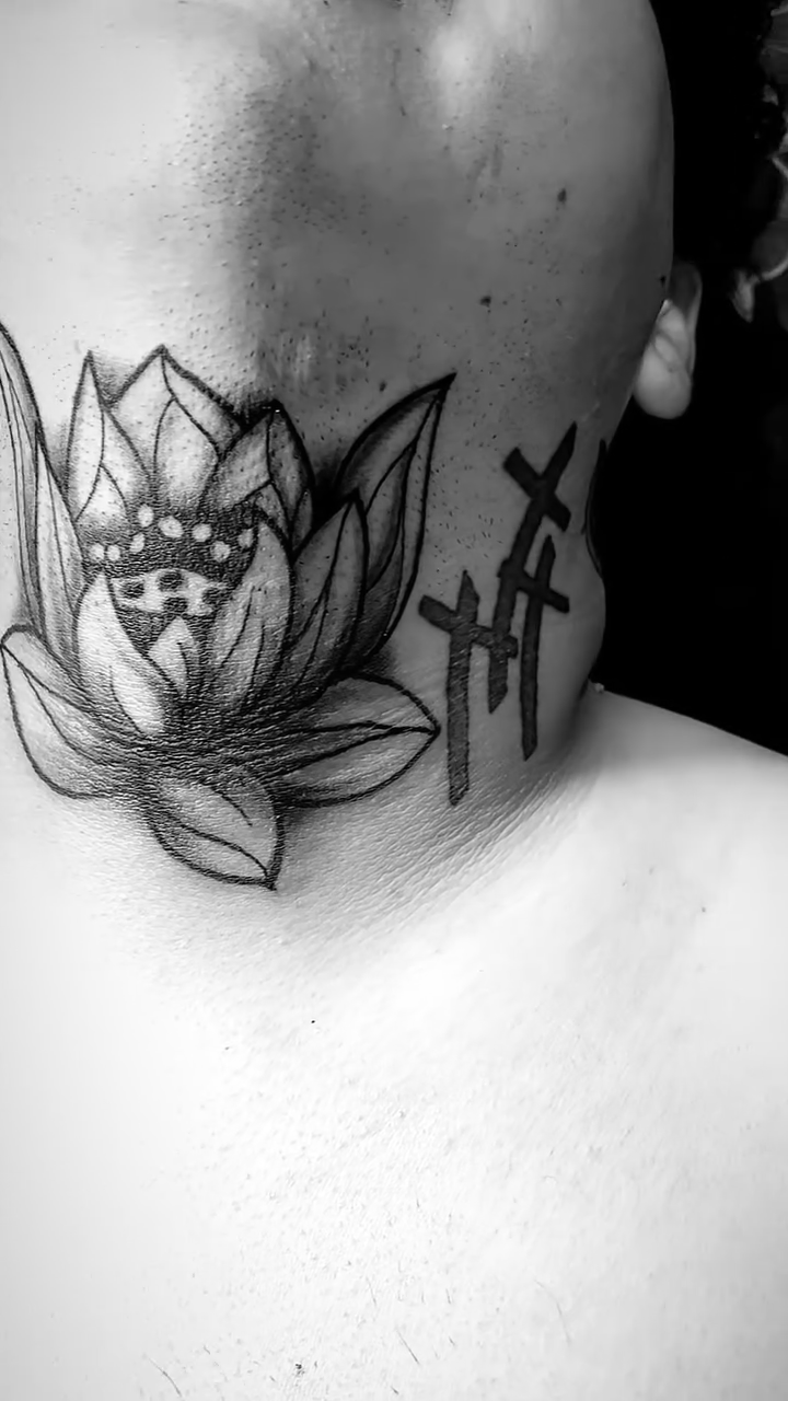 Lotus flower and crosses realism tattoo by Eli Flores
