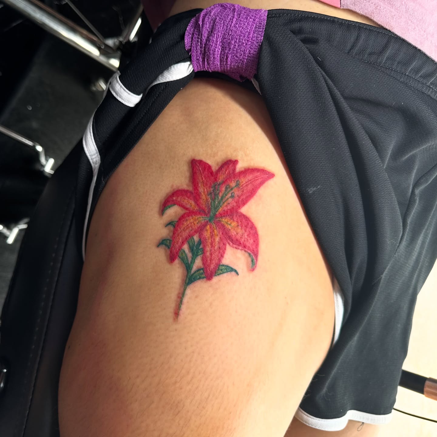 Lily realism tattoo on the thigh by Jinx Ryder