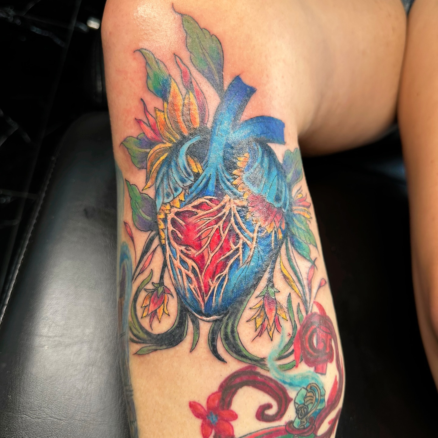 Anatomical heart with floral elements new school tattoo on the forearm by Jinx Ryder