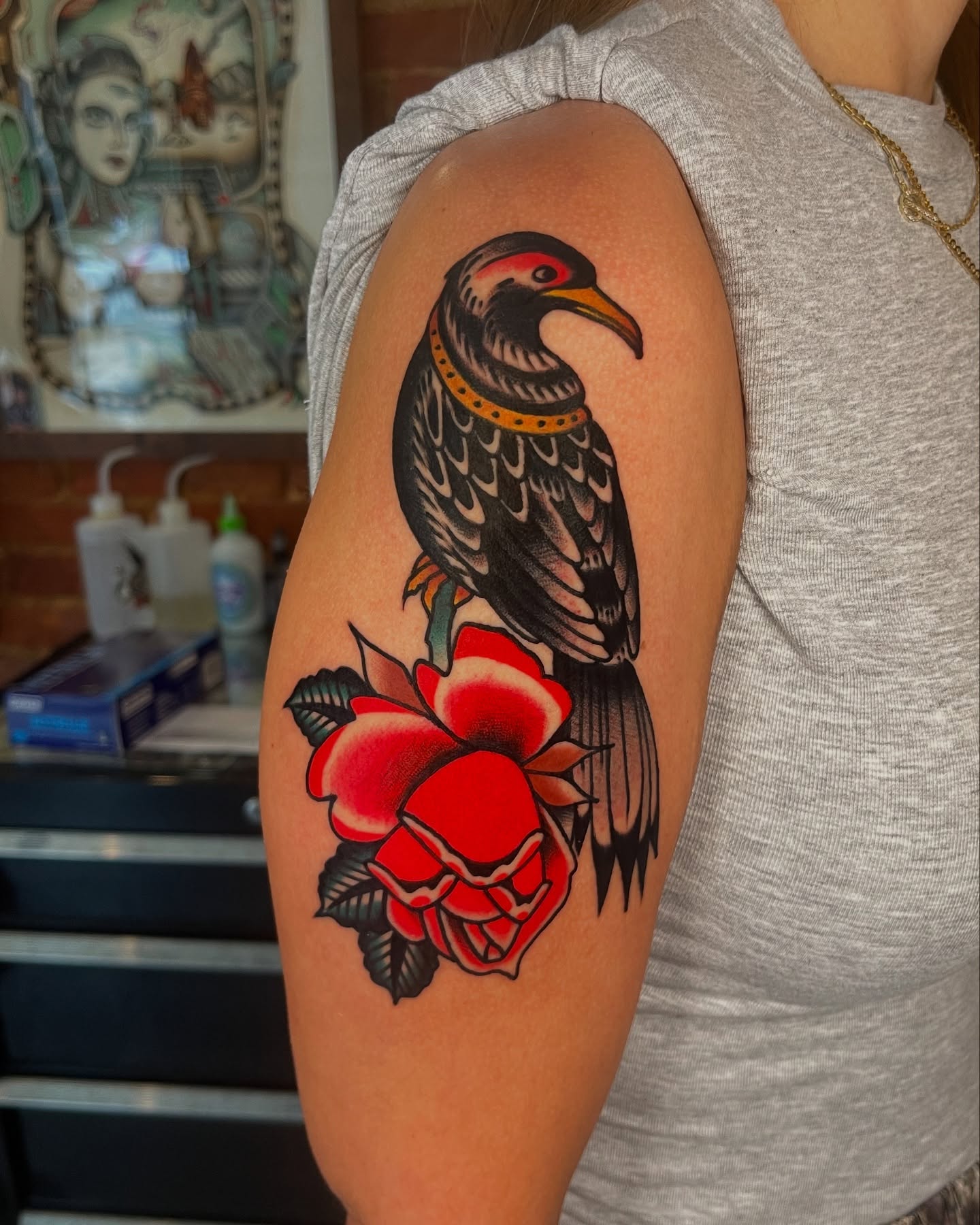 Bird and roses American traditional tattoo on the upper arm by Jeff Miller philly traditional tattoo