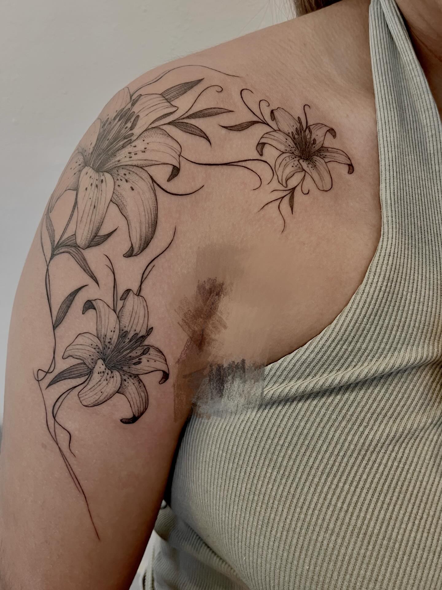 Lilies black and grey tattoo on the shoulder by Kite.Tattoo_Amber