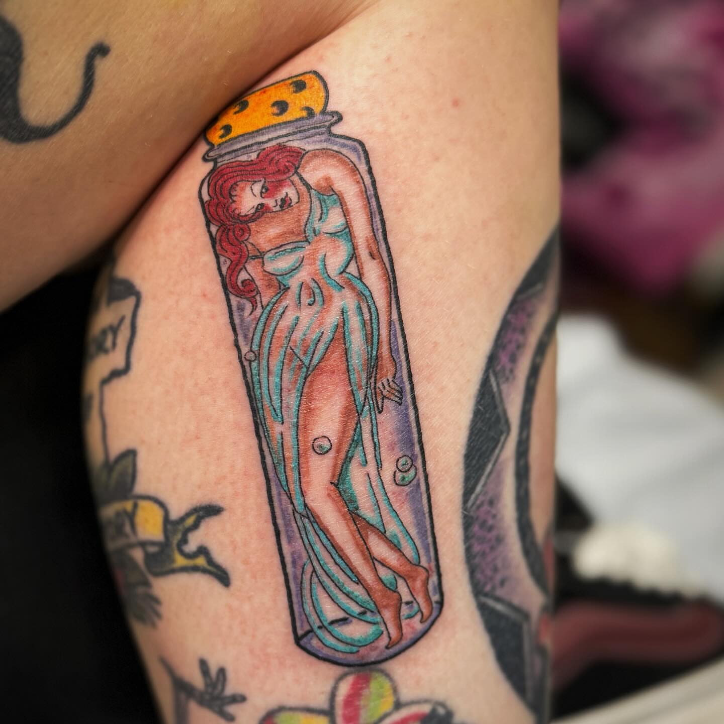 Mermaid in jar tattoo on the forearm by Jacie Aasen-Lupino