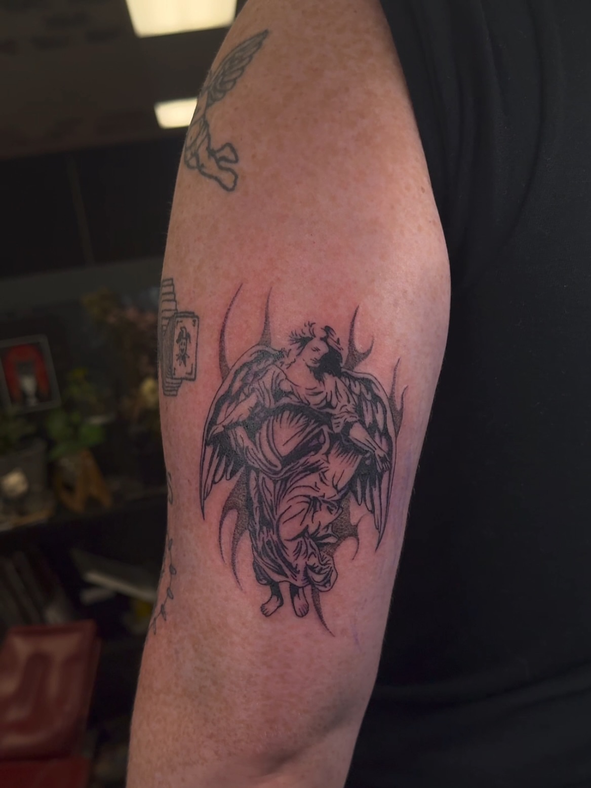 Angel with child black and grey tattoo on the forearm by πππͺ‘