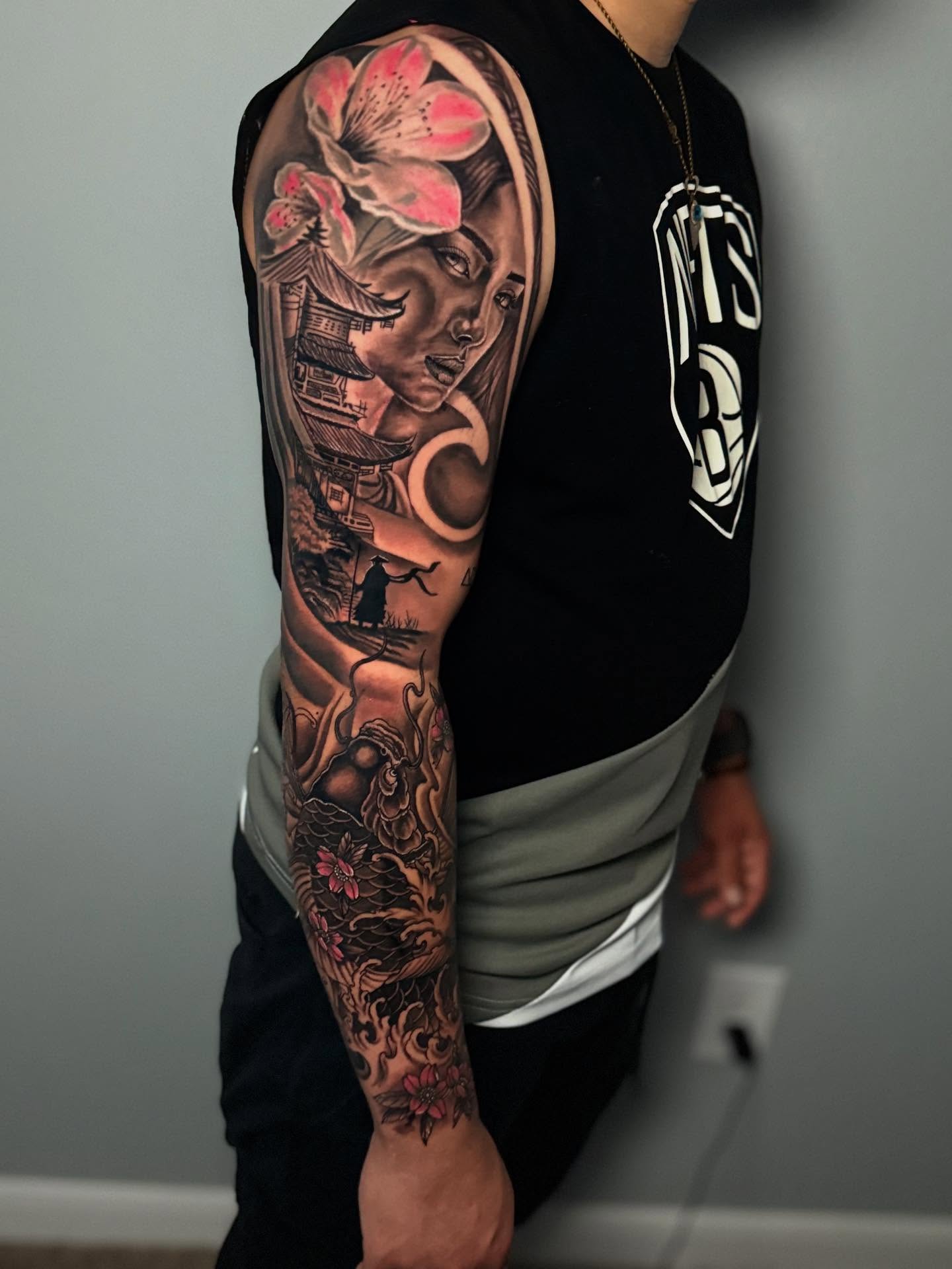 Woman with flowers japanese irezumi tattoo on the upper arm by J Camilo Rincon