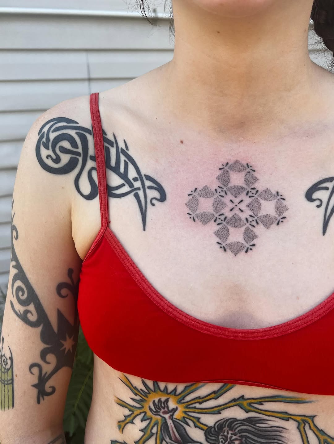 Geometric pattern ornamental tattoo on the chest by faith