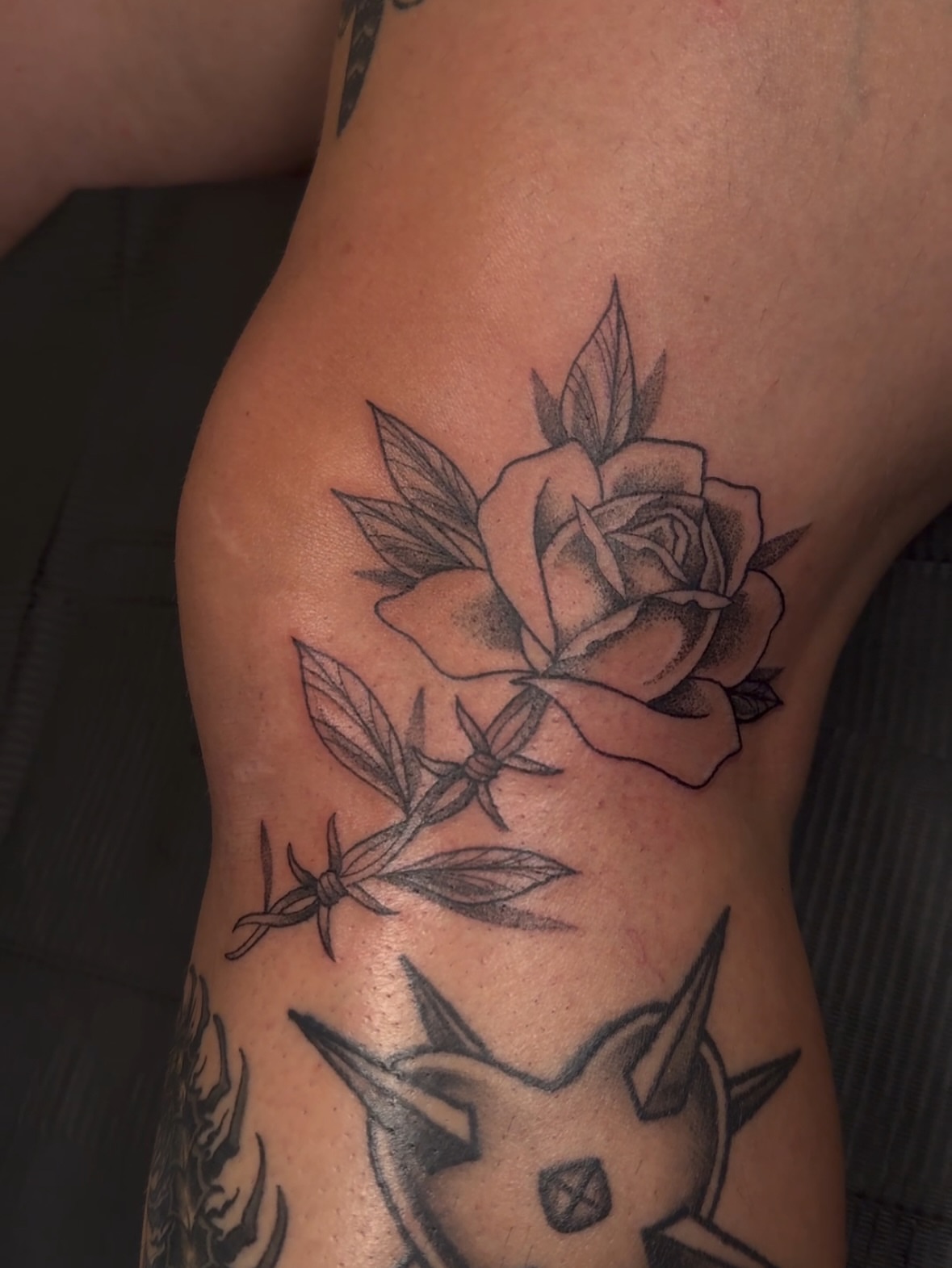 Rose with barbed wire black and grey tattoo on the thigh by πππͺ‘