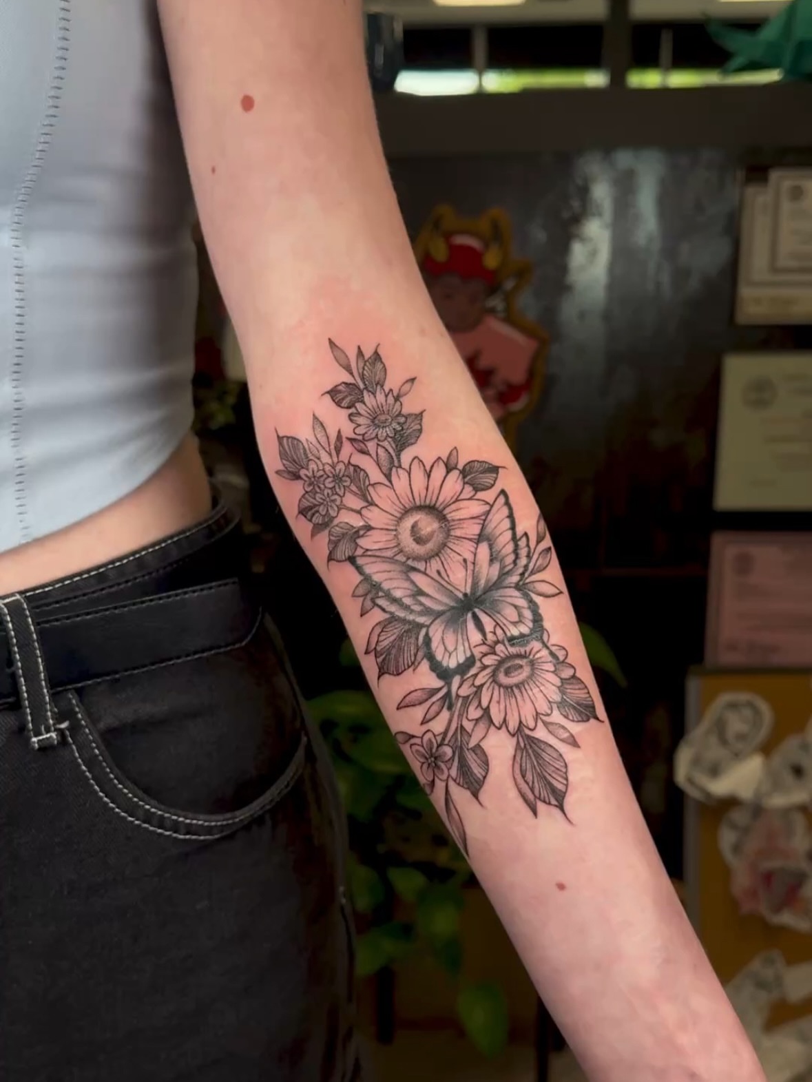 Flowers and butterfly black and grey tattoo on the forearm by πππͺ‘