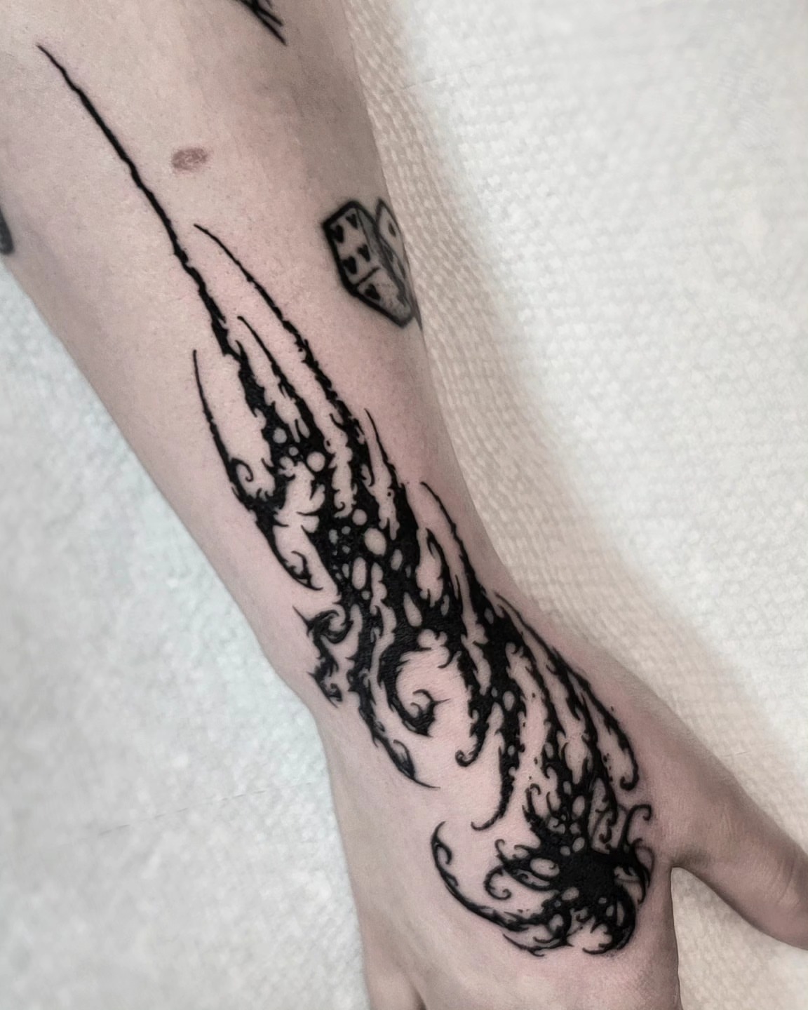Flame black and grey tattoo on the forearm by Luca