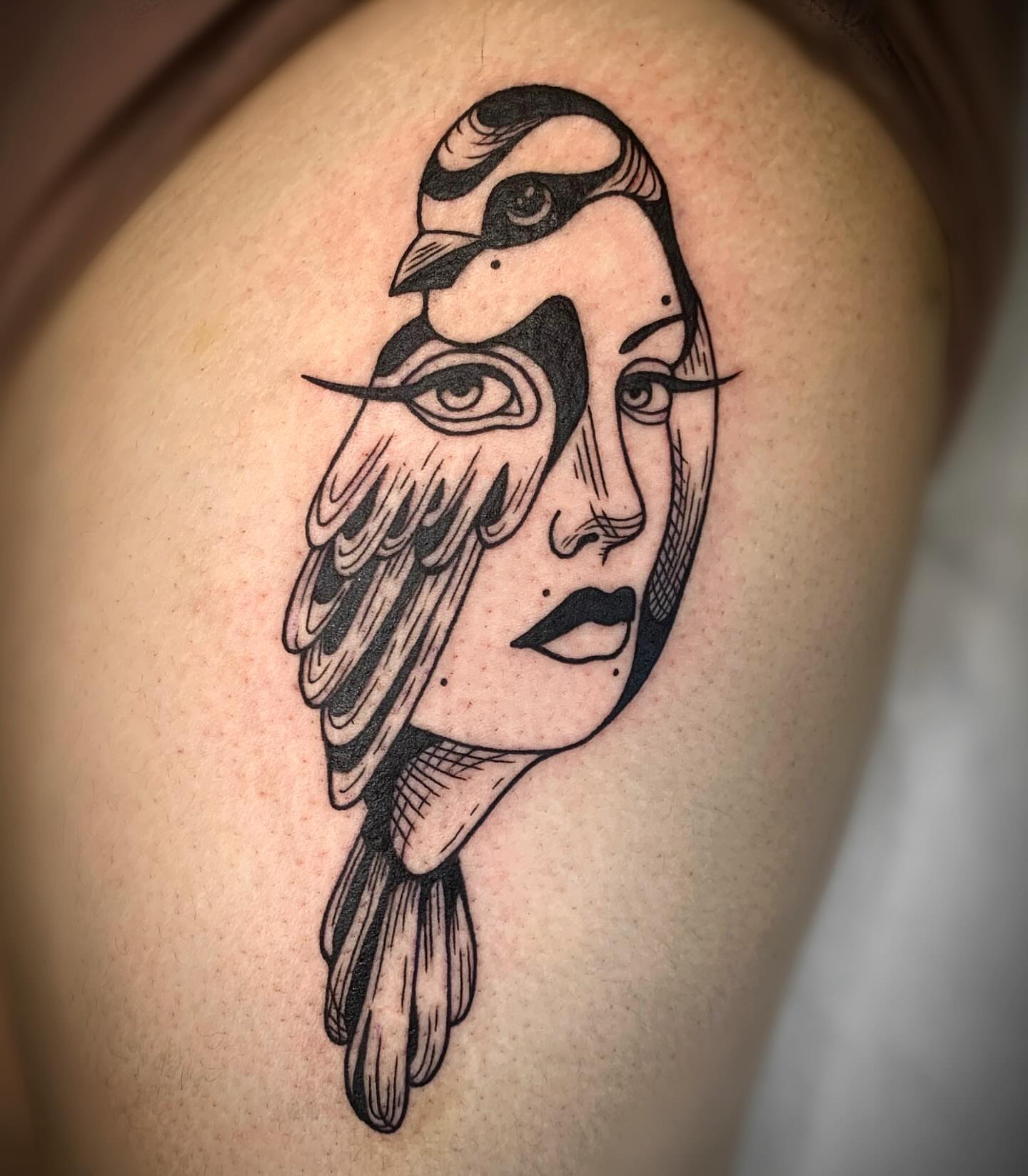 Bird and woman geometric tattoo on the shoulder by Ava Glory Tattoos
