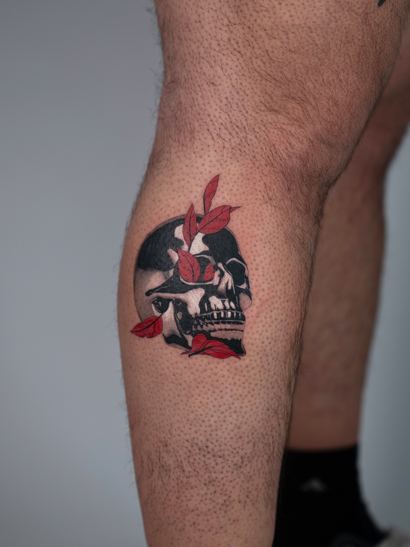 Skull with leaves dotwork tattoo on the forearm by Jerm Lewis