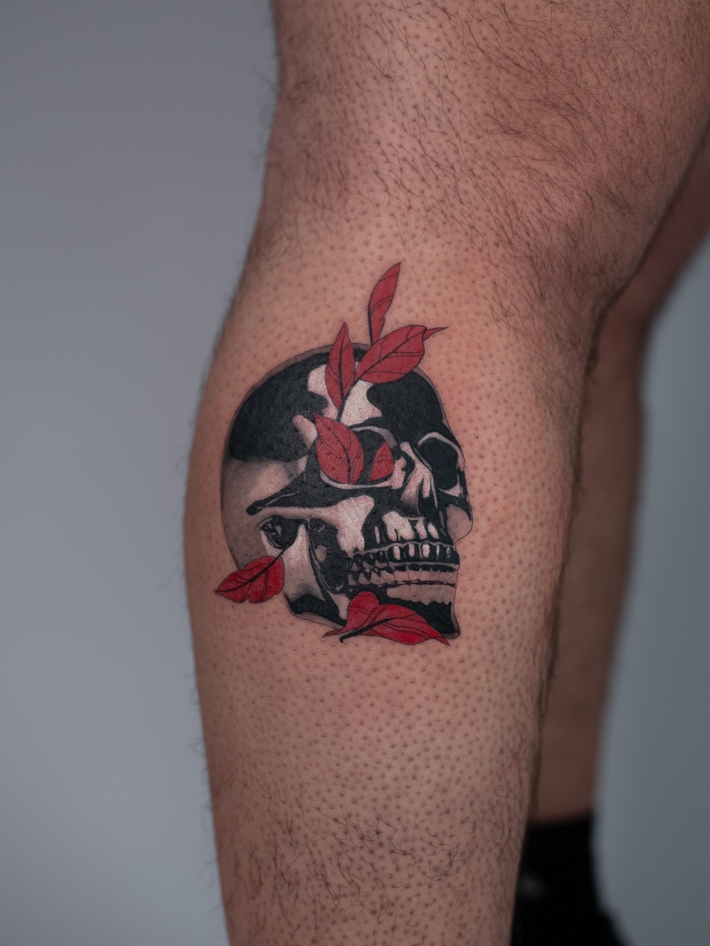 Skull with leaves dotwork tattoo on the thigh by Jerm Lewis
