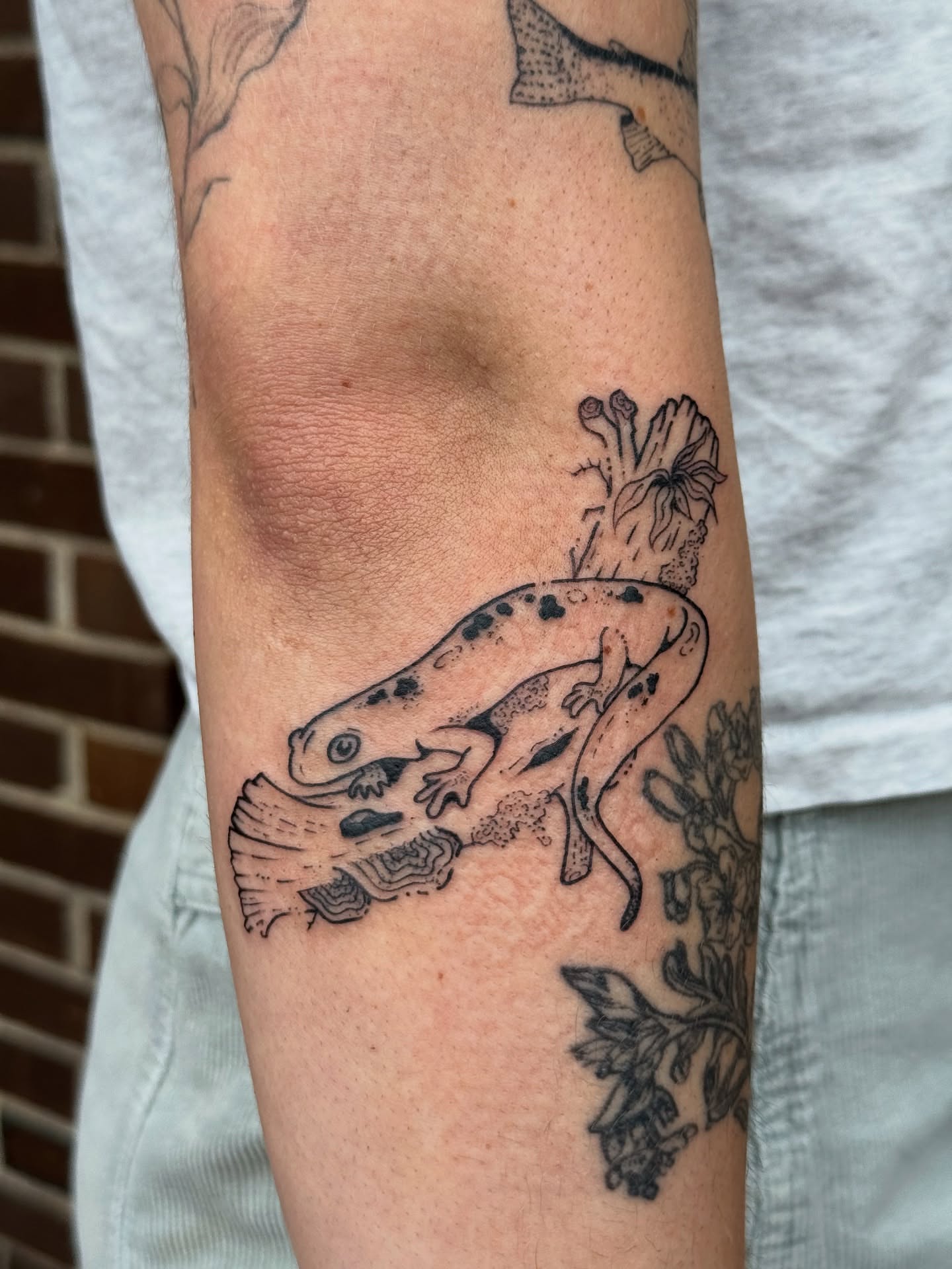 Lizard black and grey tattoo on the forearm by Milo