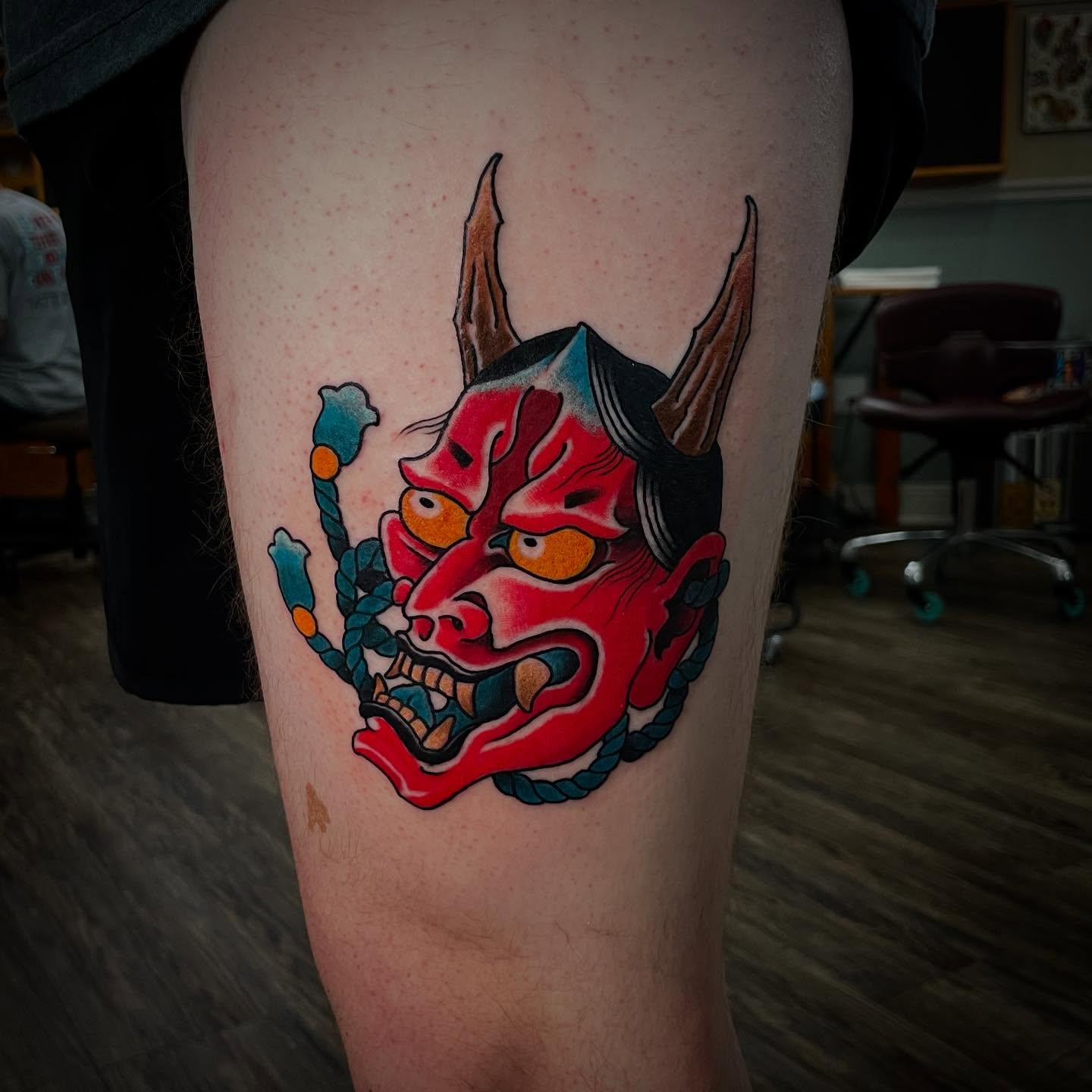 Demon mask japanese irezumi tattoo on the thigh by Caleb Baker