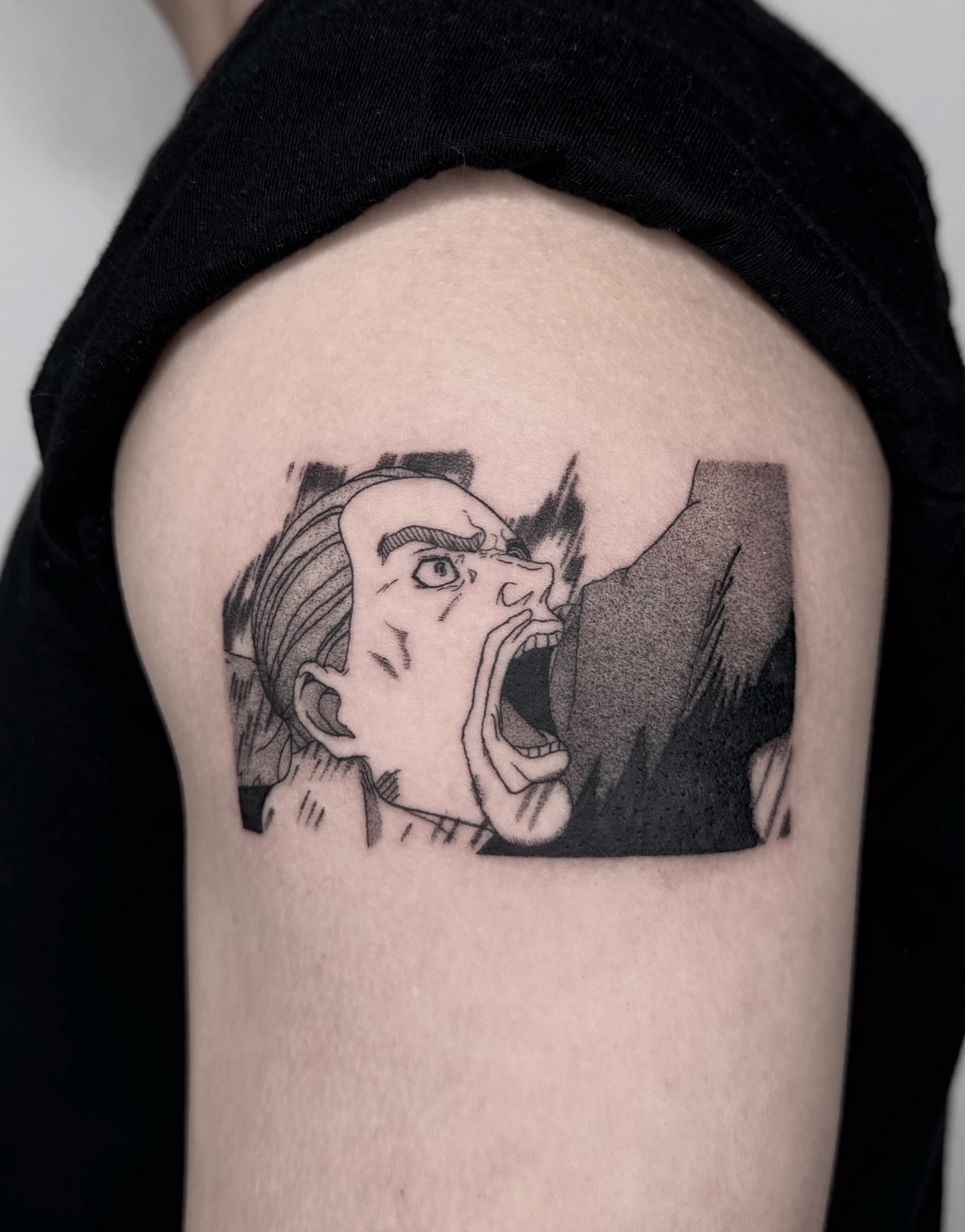 Angry face black and grey tattoo on the shoulder by Leo