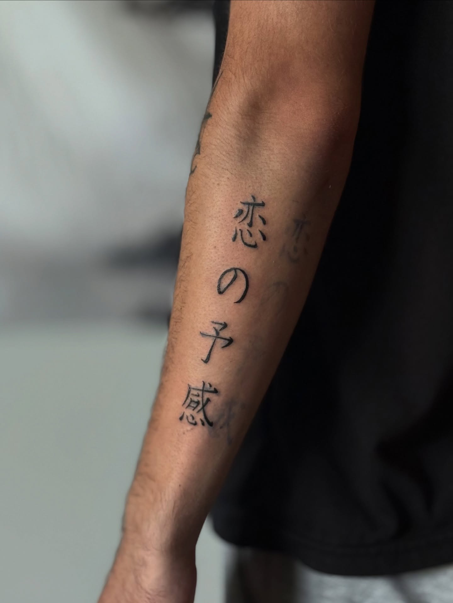 Kanji characters black and grey tattoo on the forearm by Khang🇻🇳