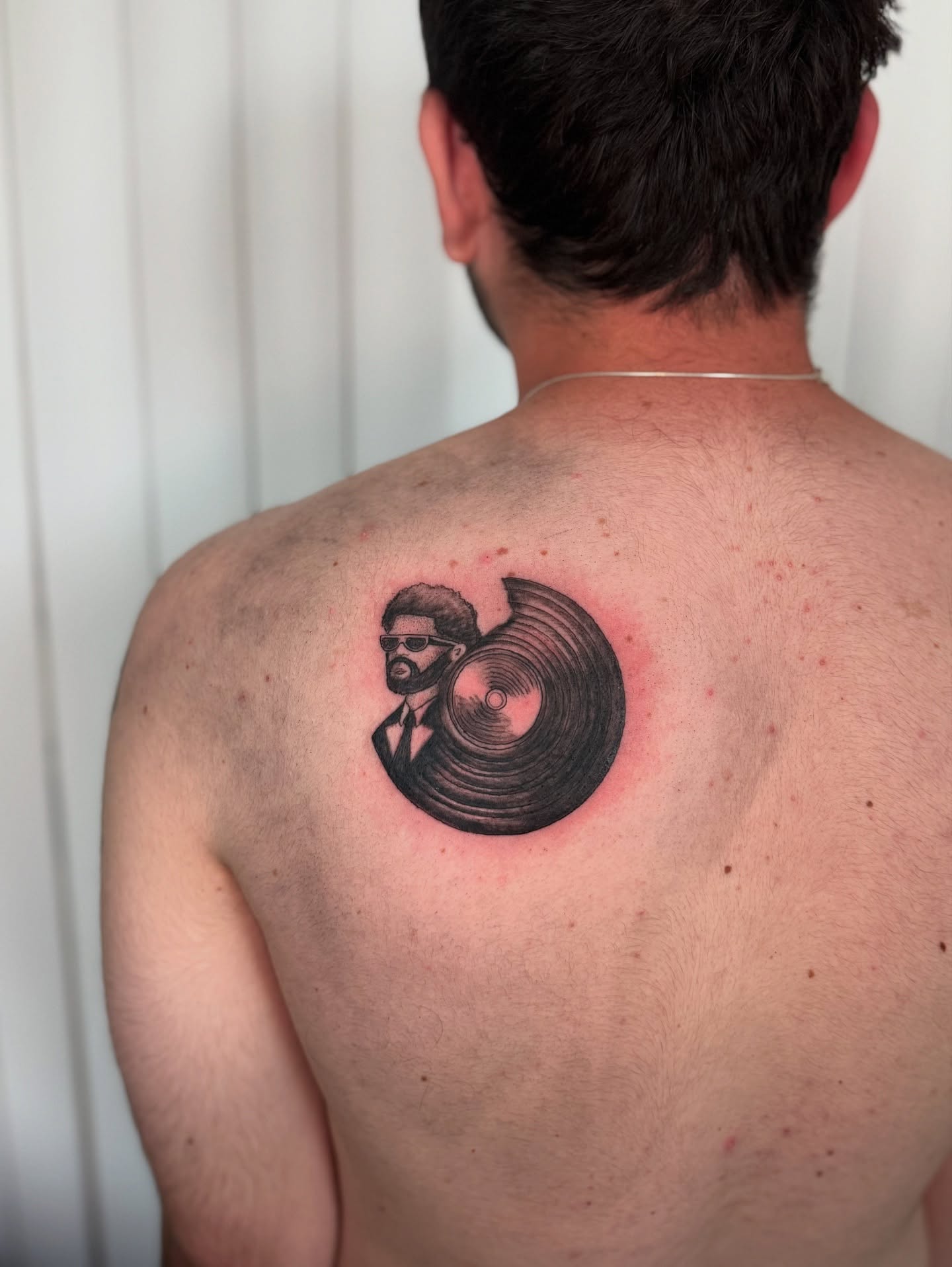 Vinyl record and man realism tattoo on the back by Khang🇻🇳