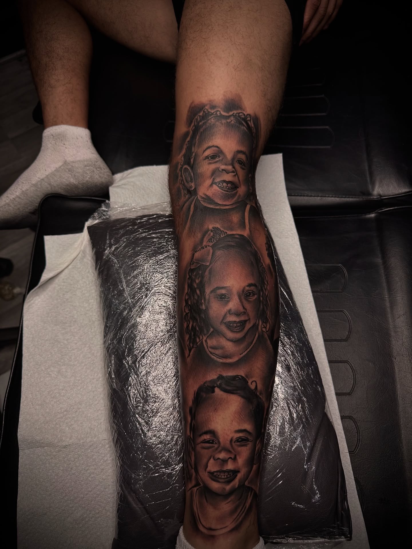 Children's faces realism tattoo on the forearm by Zeus